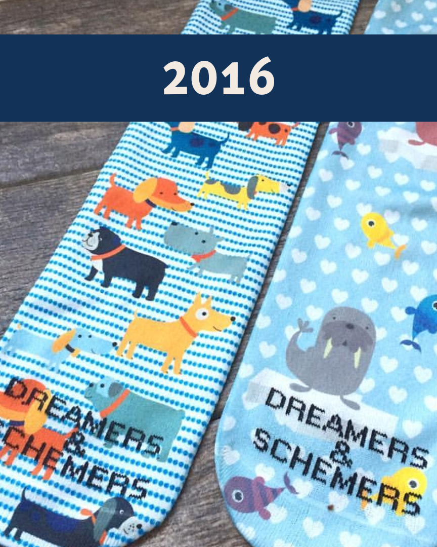 Limited edition 2016 Dog Park boot socks with playful dog illustrations and black cuffs
