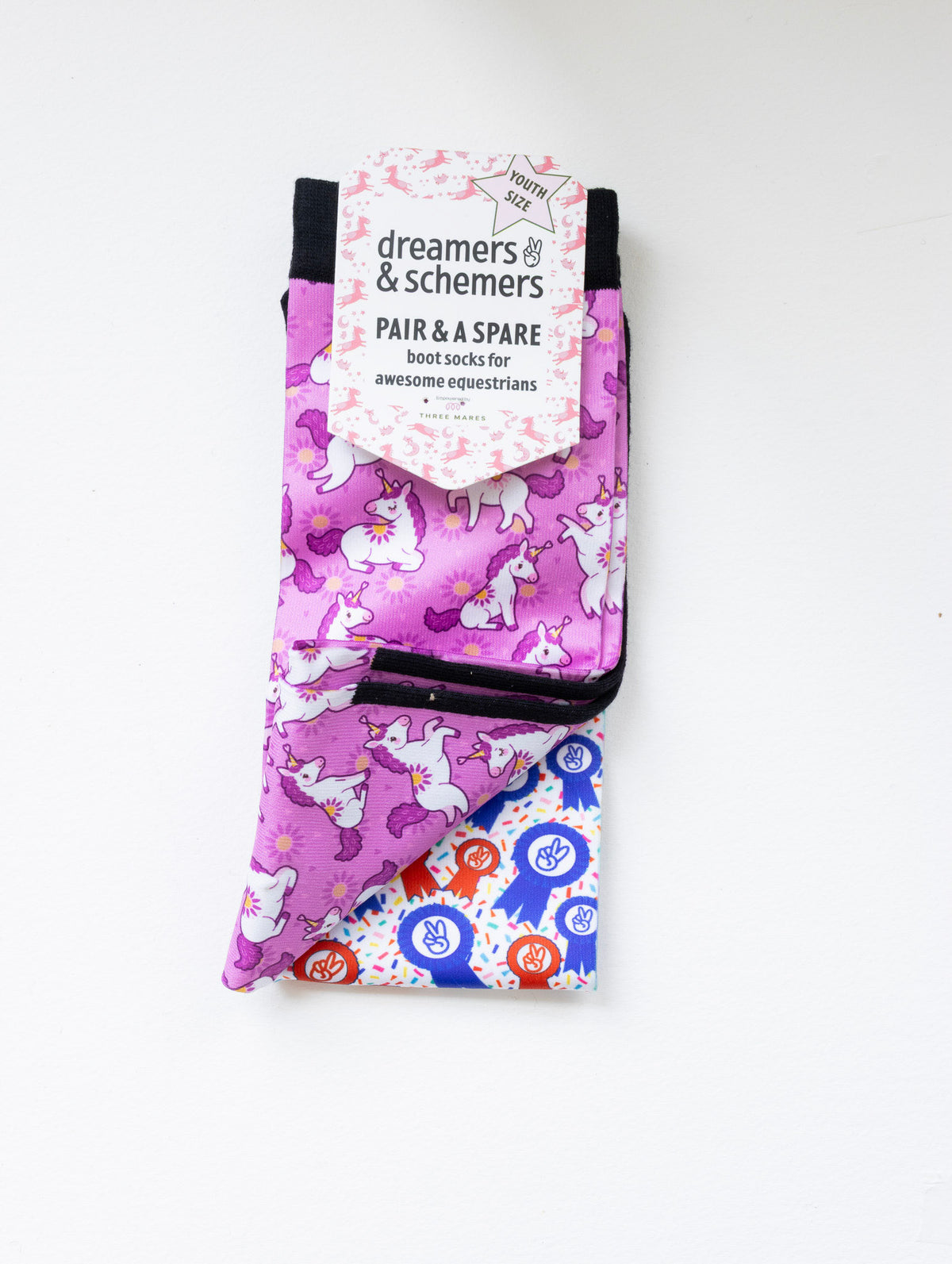 Sunshine and Unicorns youth boot socks shown folded with the included spare sock and patterned cuff