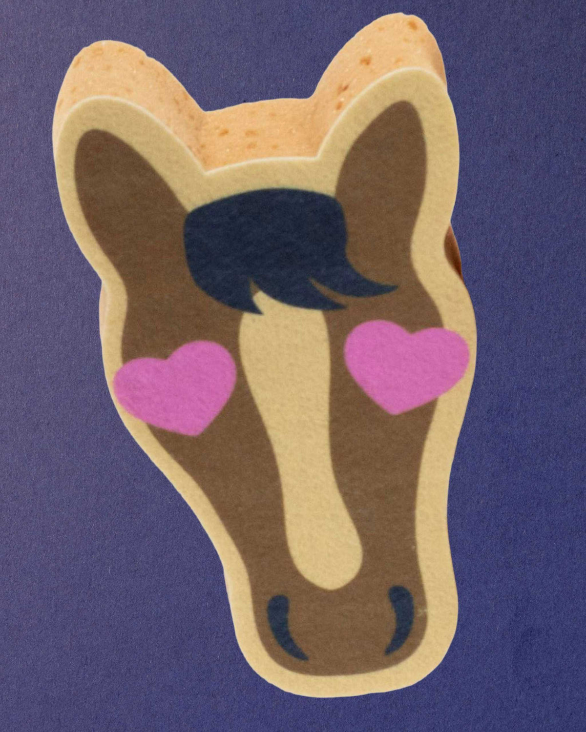 Pony Love expanding bath sponge at an angle so the sponge thickness and textured edge show