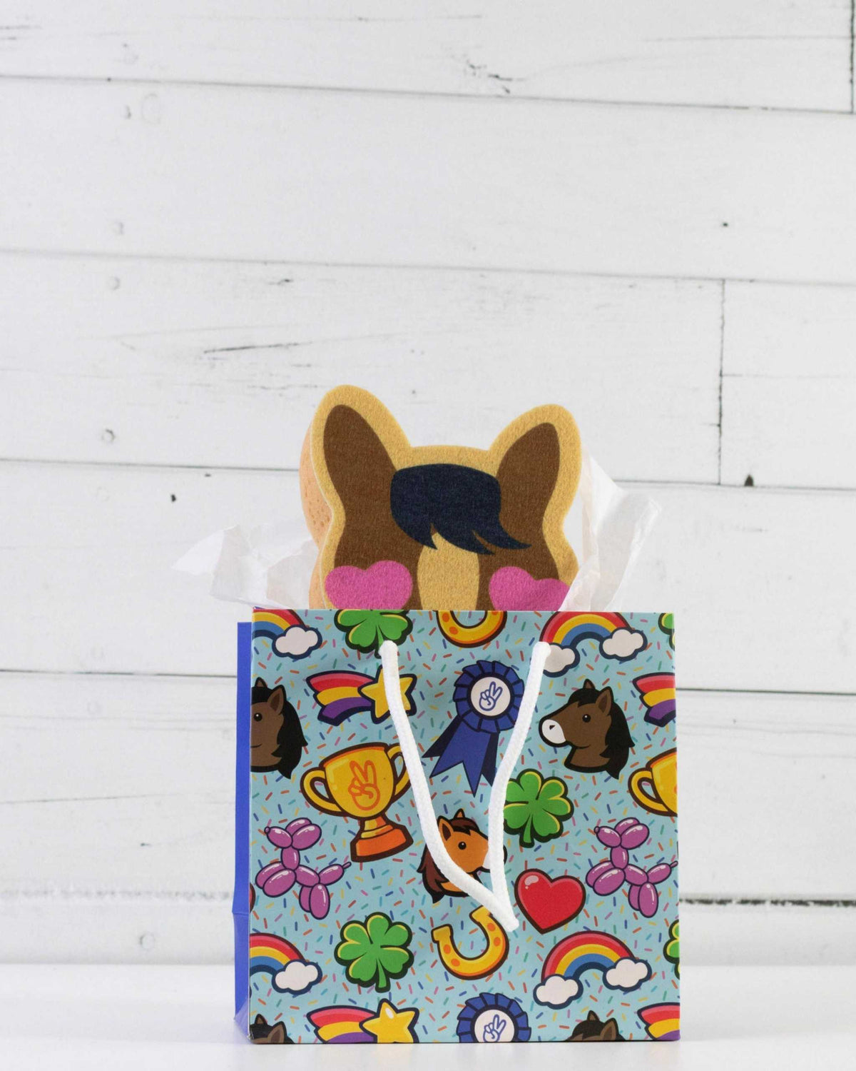 Pony Love bath sponge styled with other Dreamers & Schemers accessories on a white shelf