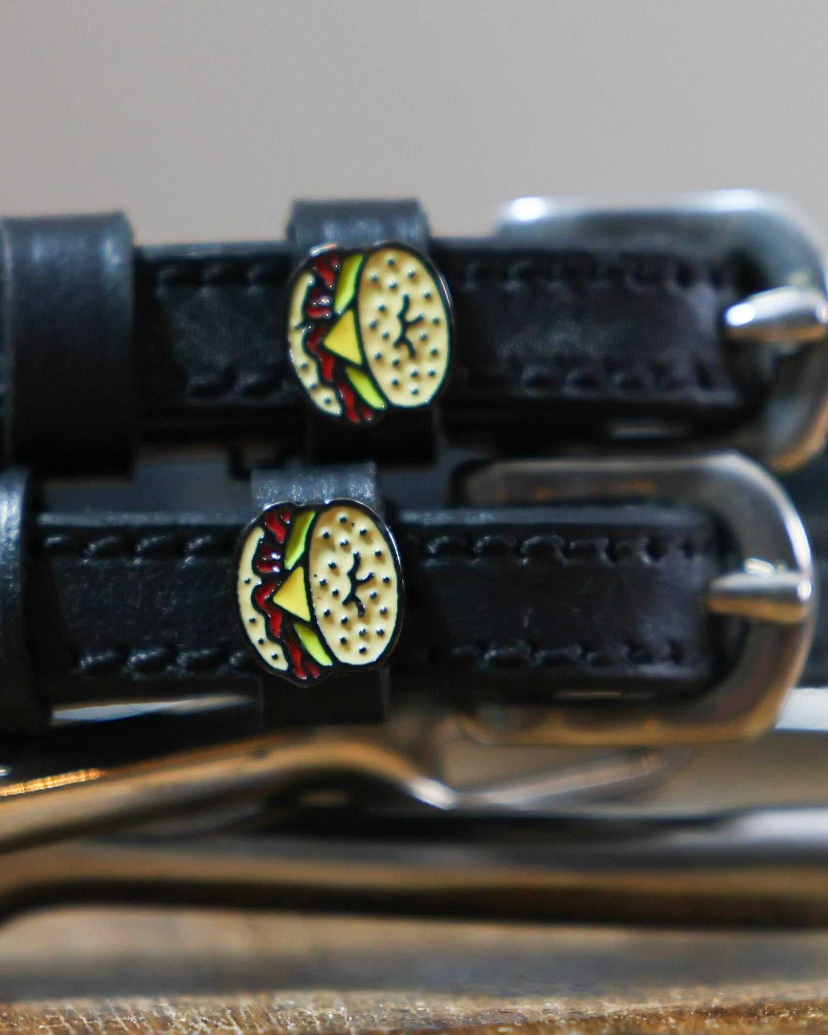 Black leather bagel sandwich spur straps with stainless steel buckles and custom charms
