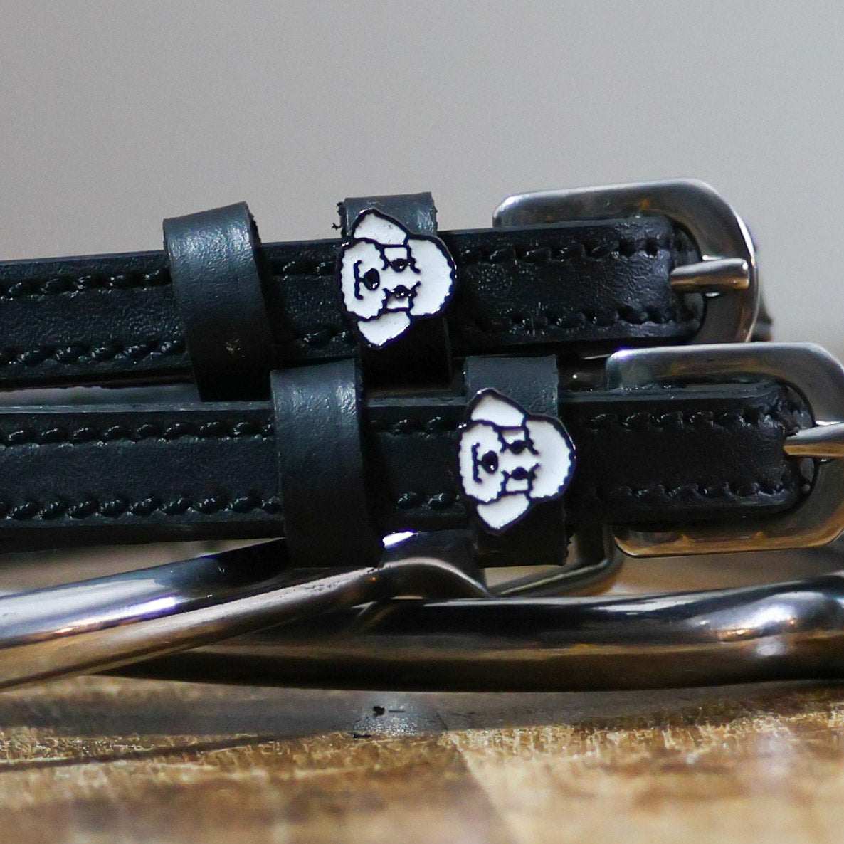 Black leather spur straps with stainless steel buckles and poodle dog charms