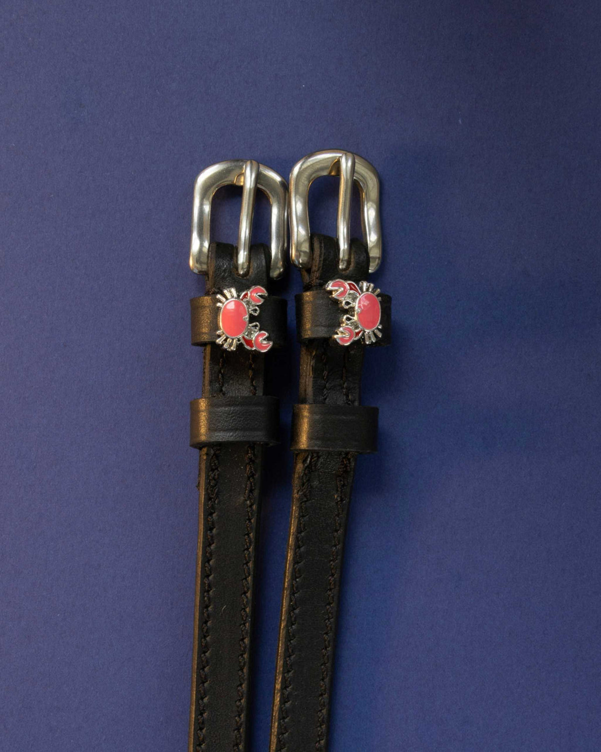 Crabbin' ManeJane spur straps with the signature Crabbin' charm, shown on a navy background