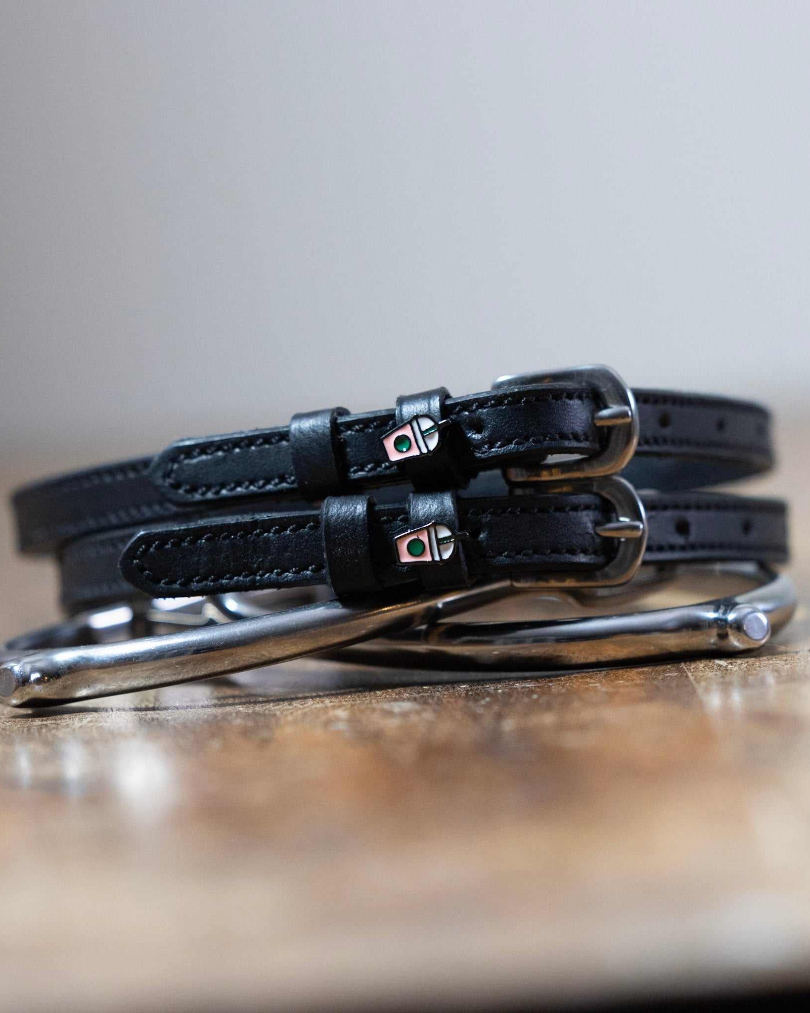 Black leather Frappe Spur Straps with stainless steel buckles and custom ManeJane charm