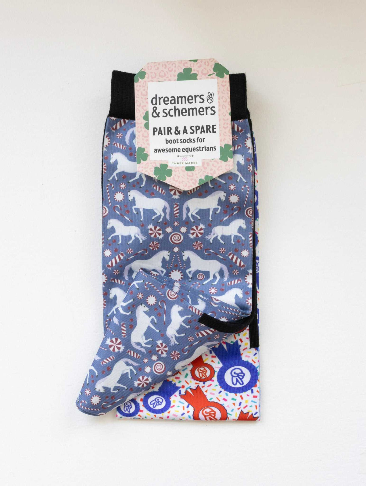 The Pony Island Peppermint Ponies youth boot socks shown folded with the included spare sock and patterned cuff