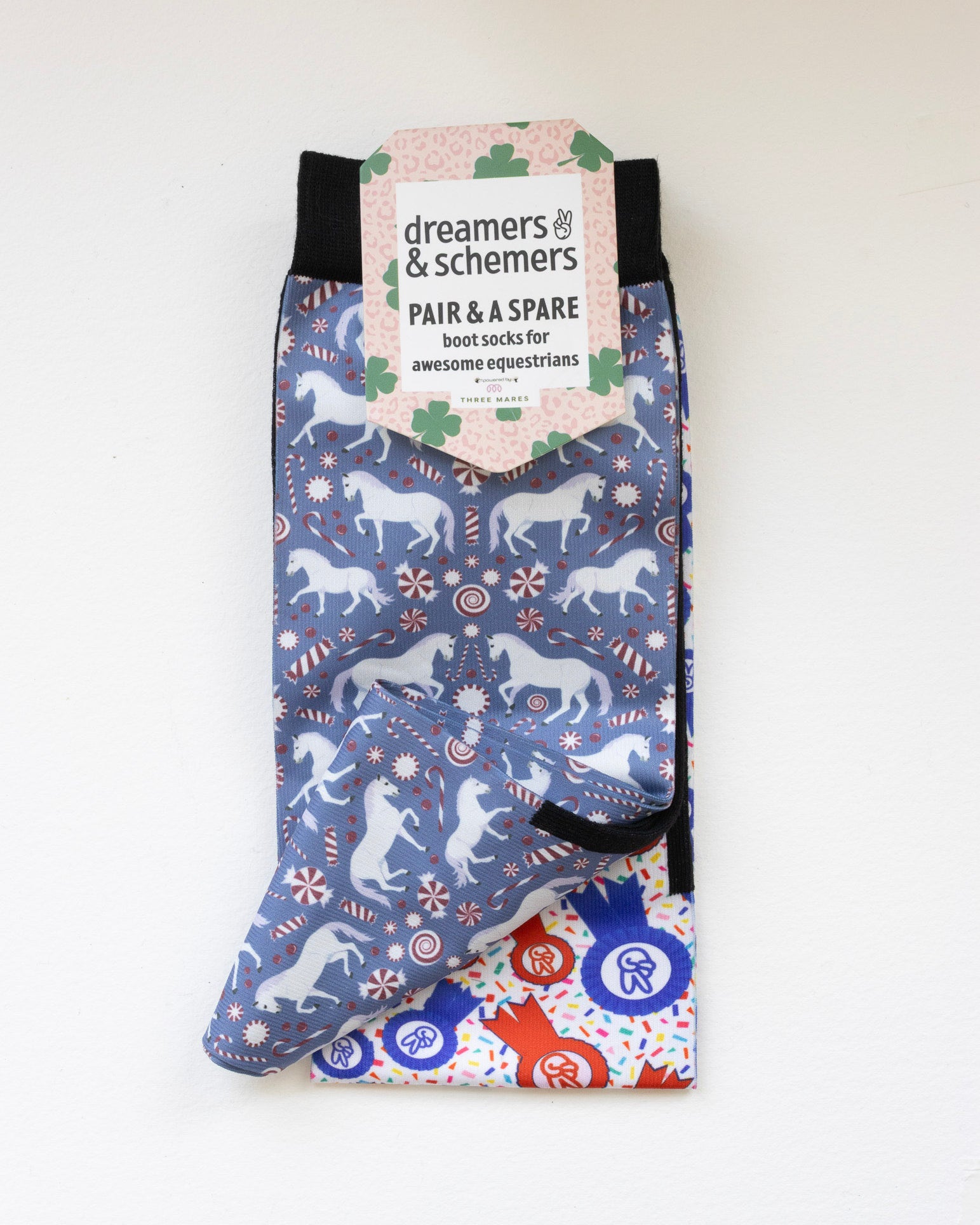 The Pony Island Peppermint Ponies boot socks shown folded with the included spare sock and printed cuff detail
