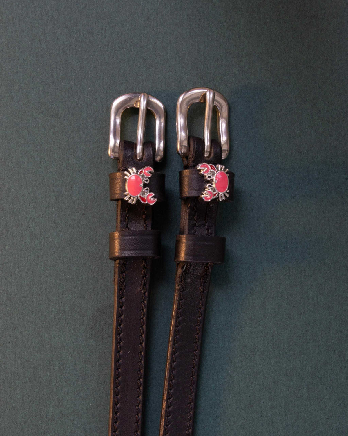 Crabbin' ManeJane spur straps with the signature Crabbin' charm, shown on a charcoal background