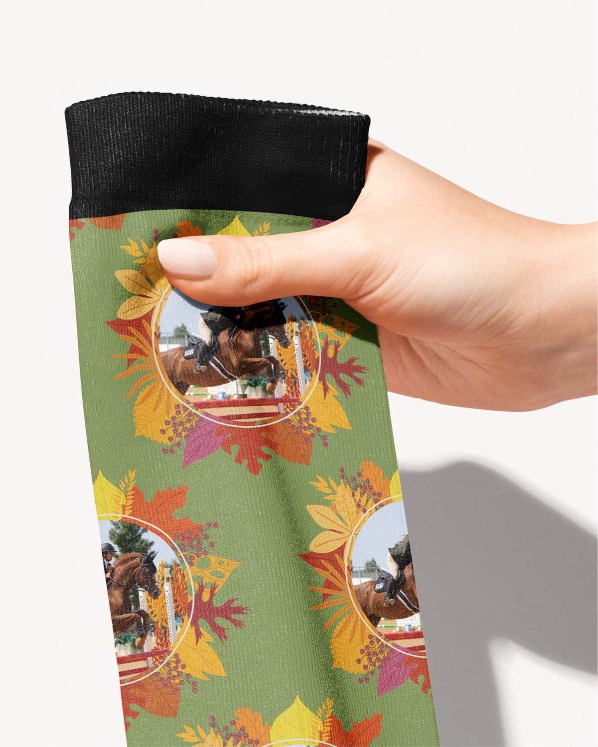 Autumn Leaves custom photo equestrian boot socks, held in hand, close-up of the autumn-leaf wreath pattern, by Dreamers & Schemers