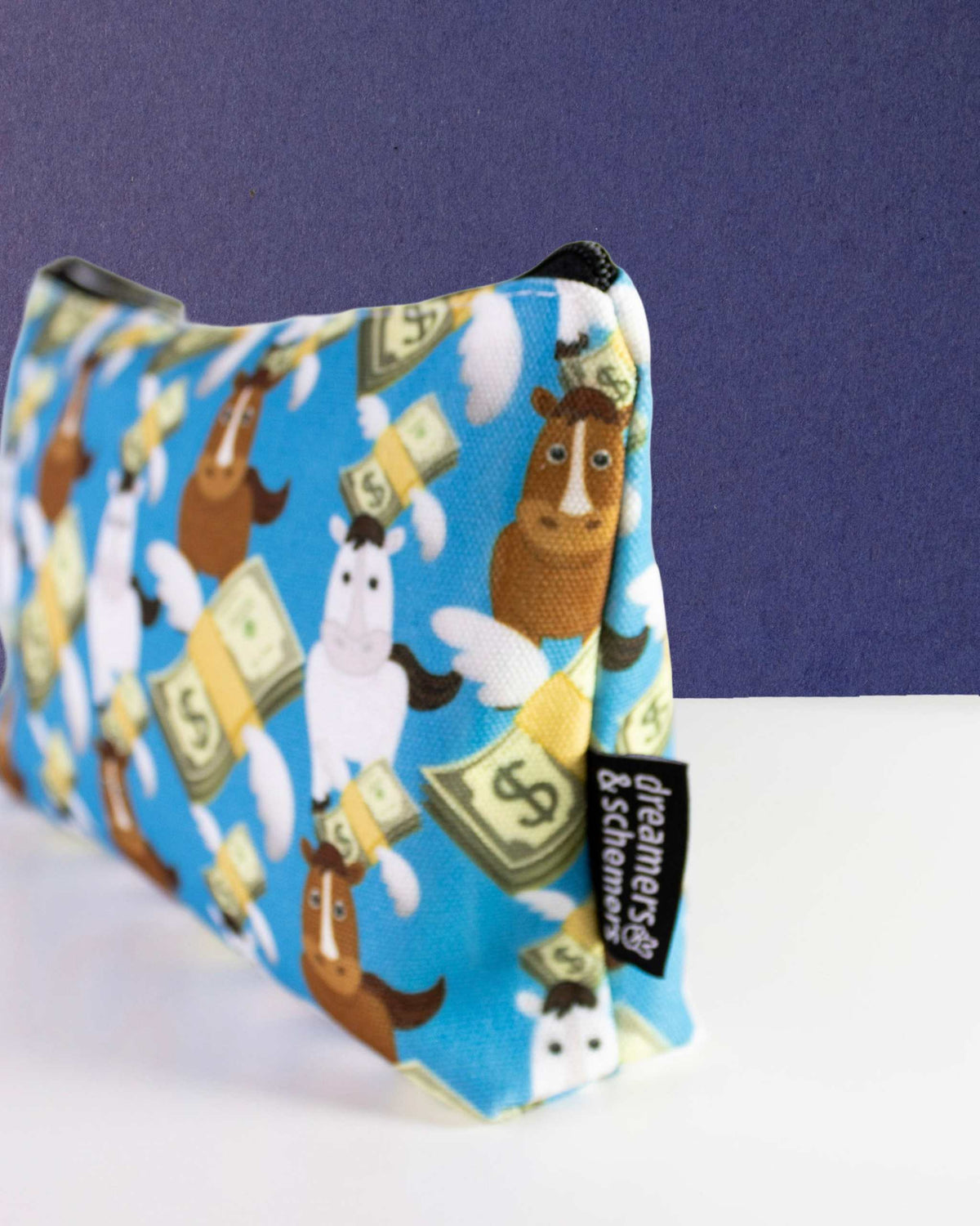 Cash Money zip pouch on its gusset, self-standing, showing the side panel and woven brand tag
