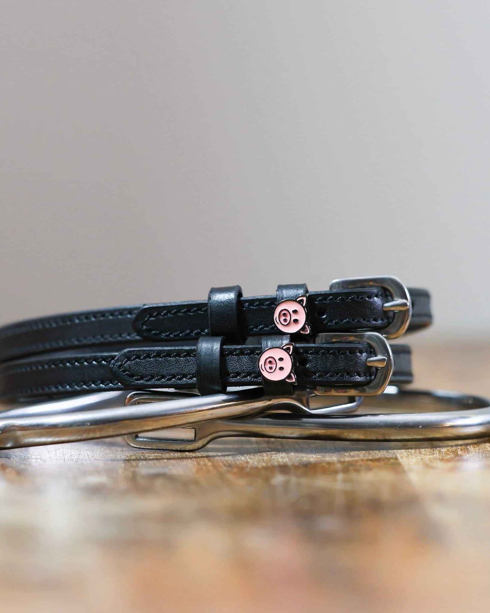 ManeJane Piggy Spur Straps Spur Straps — black leather, non-stretch, hero image for English riders.