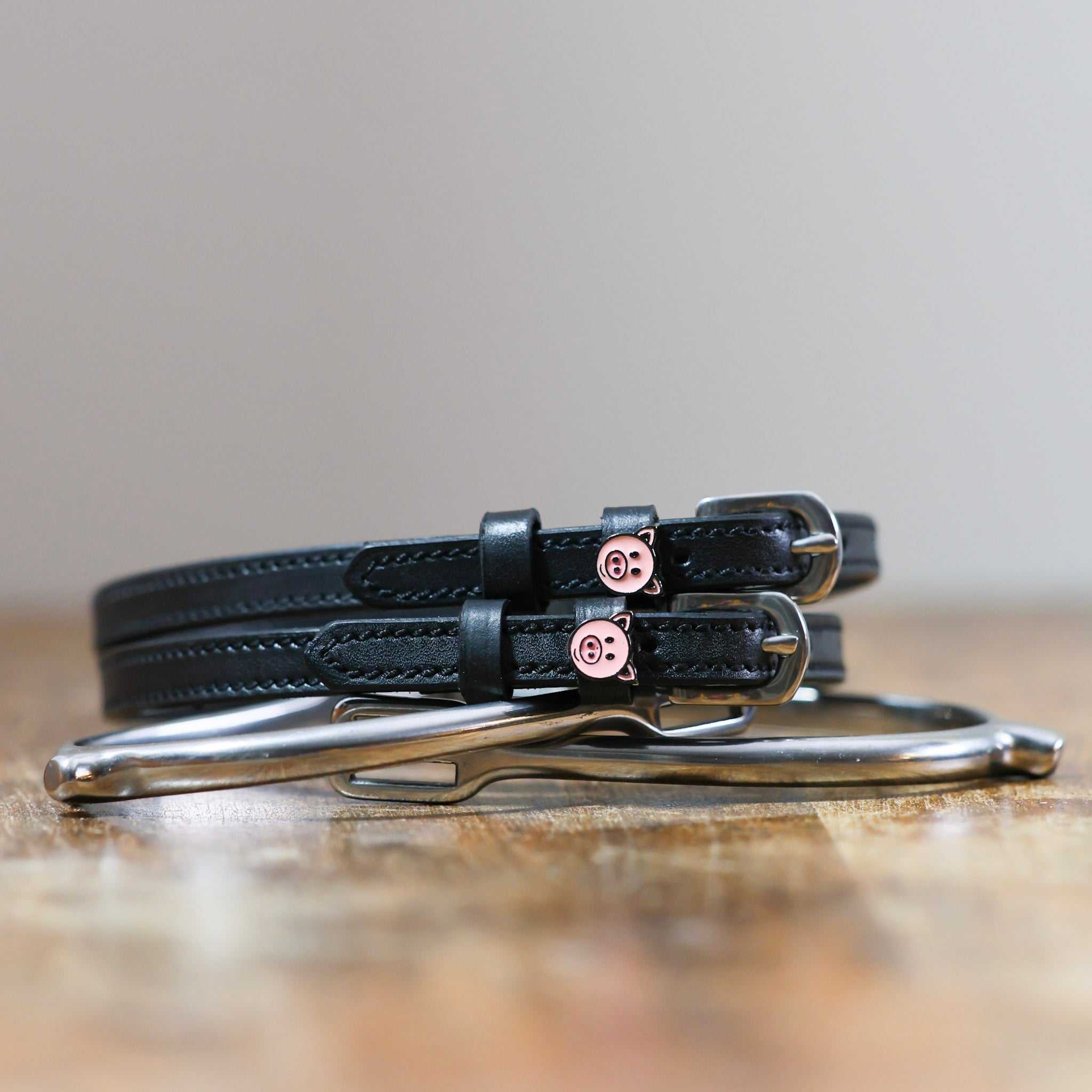 ManeJane Piggy Spur Straps Spur Straps — black leather, non-stretch, hero image for English riders.