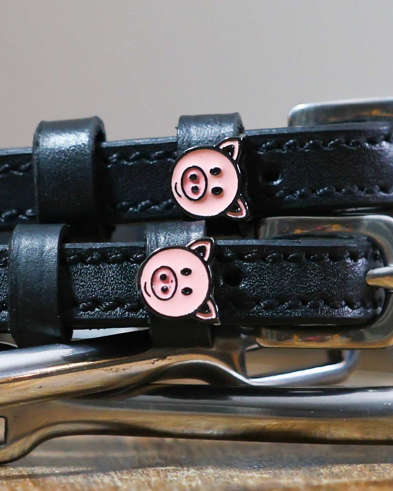 Black leather piggy charm spur straps with stainless steel buckles and two keepers