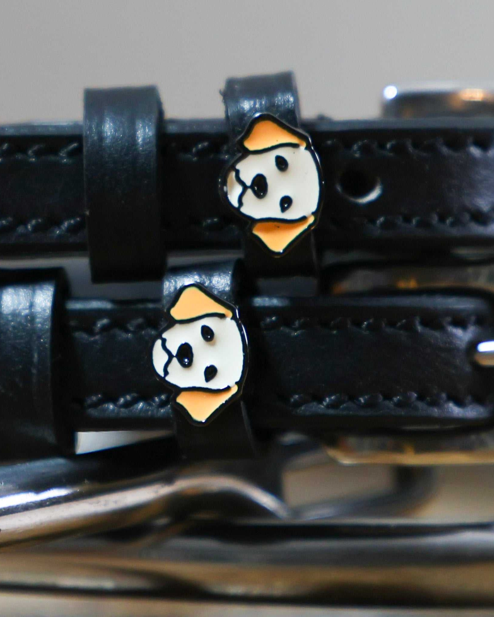 Black leather spur straps with golden retriever dog charms and stainless steel buckles