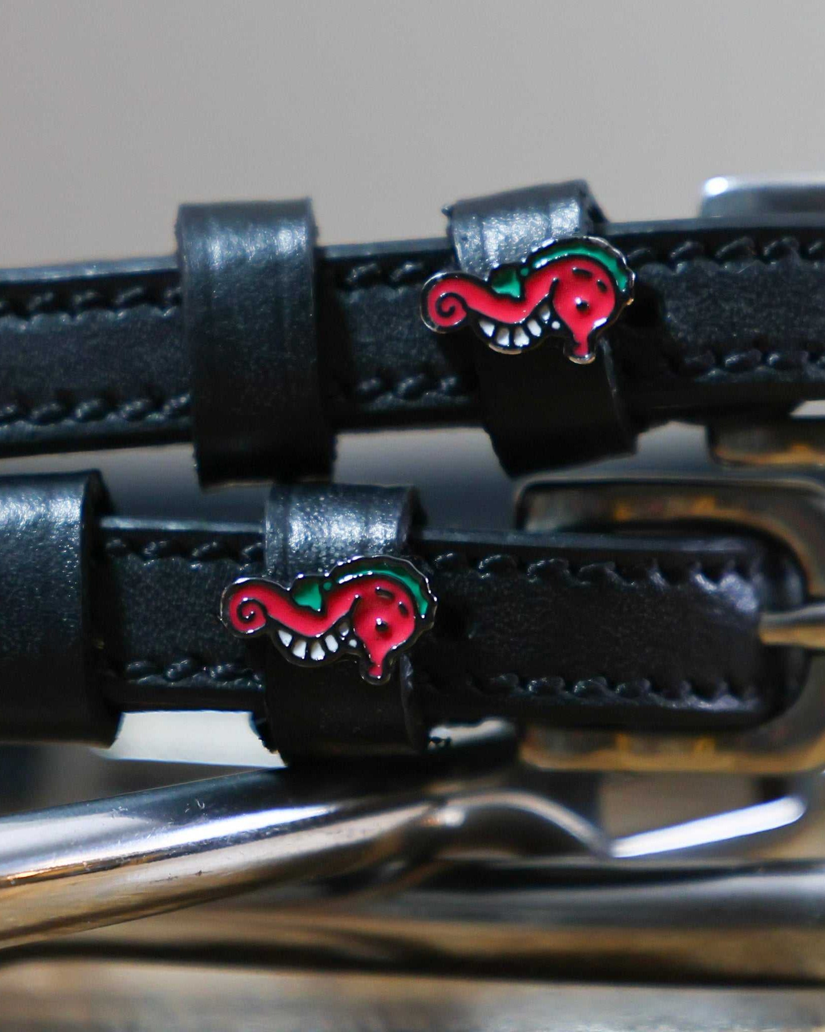 Black leather Spur Straps with stainless steel buckles and red seahorse charm