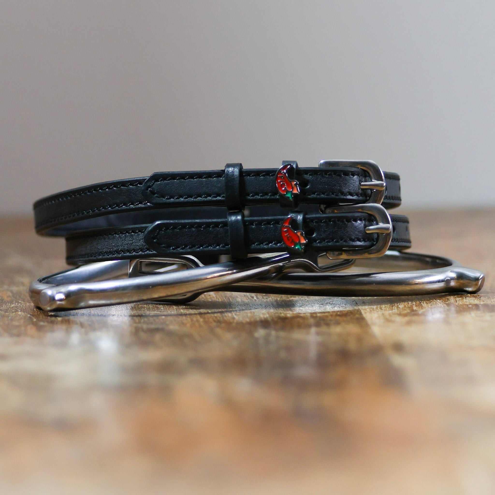 ManeJane Spicy Pepper Spur Straps Spur Straps — black leather, non-stretch, hero image for English riders.
