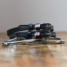ManeJane Pink Dinosaur Spur Straps Spur Straps — black leather, non-stretch, hero image for English riders.