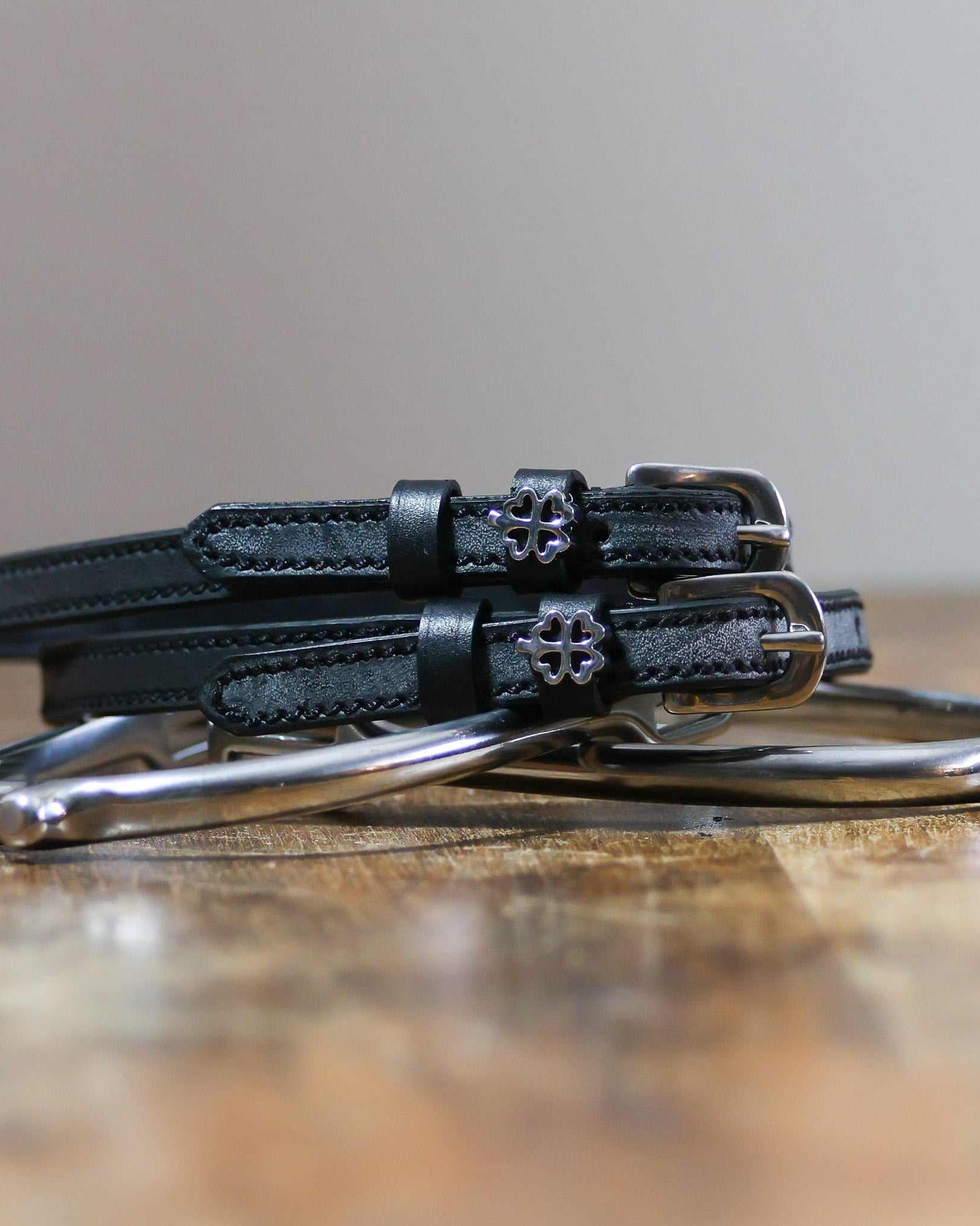 ManeJane Silver Outline Clover Spur Straps Spur Straps — black leather, non-stretch, hero image for English riders.