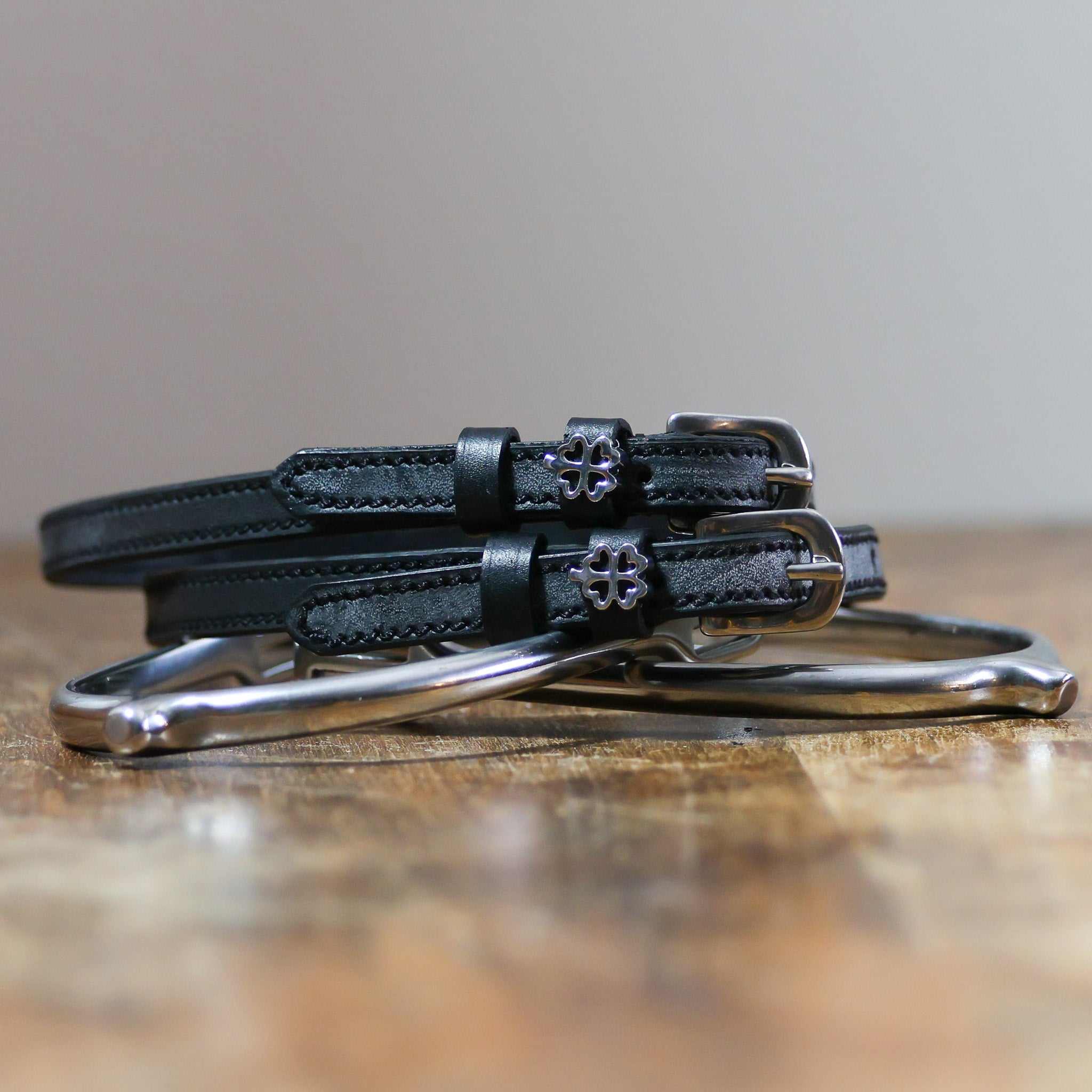 ManeJane Silver Outline Clover Spur Straps Spur Straps — black leather, non-stretch, hero image for English riders.