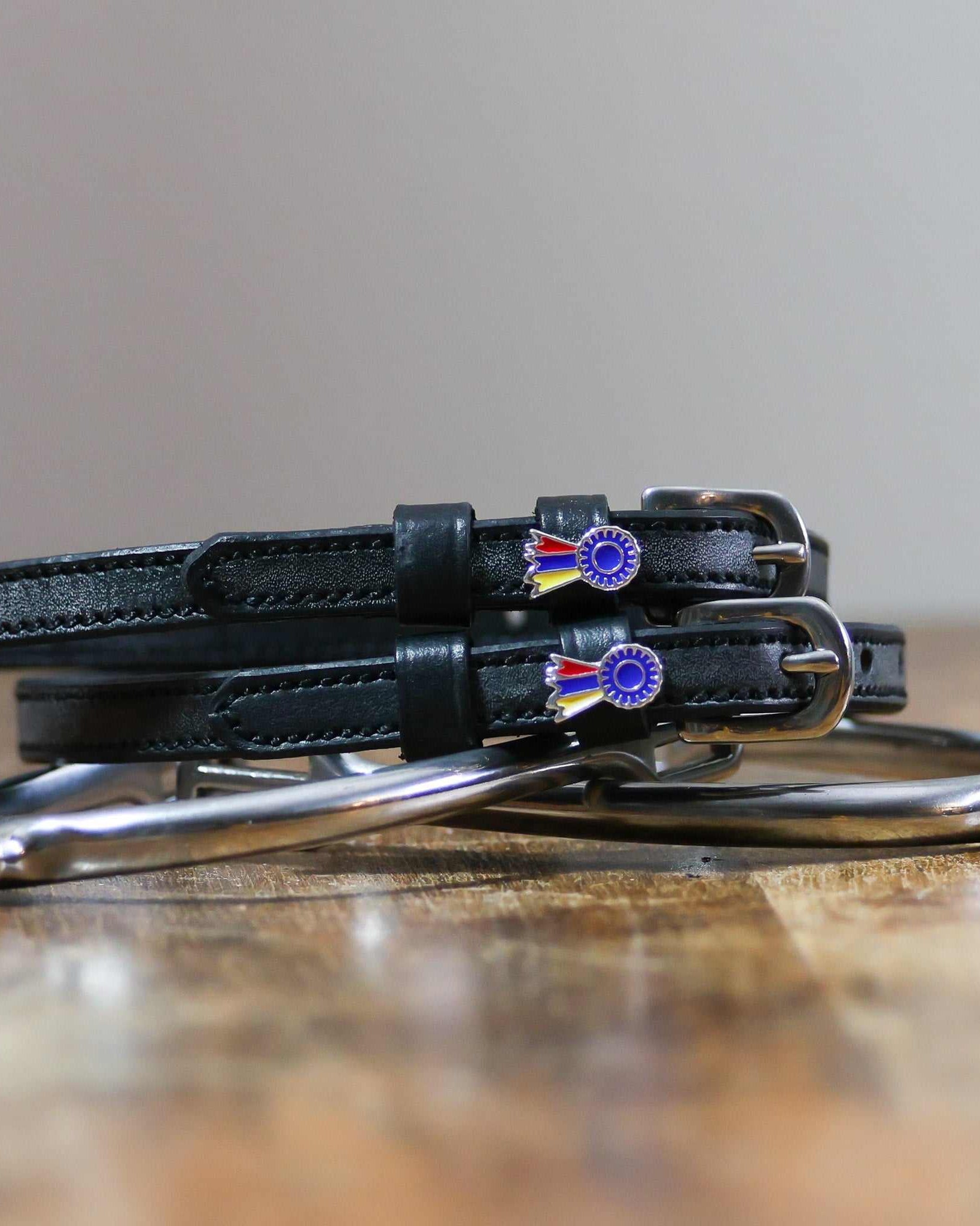 ManeJane Tri-Color Ribbon Spur Strap Spur Straps — black leather, non-stretch, hero image for English riders.