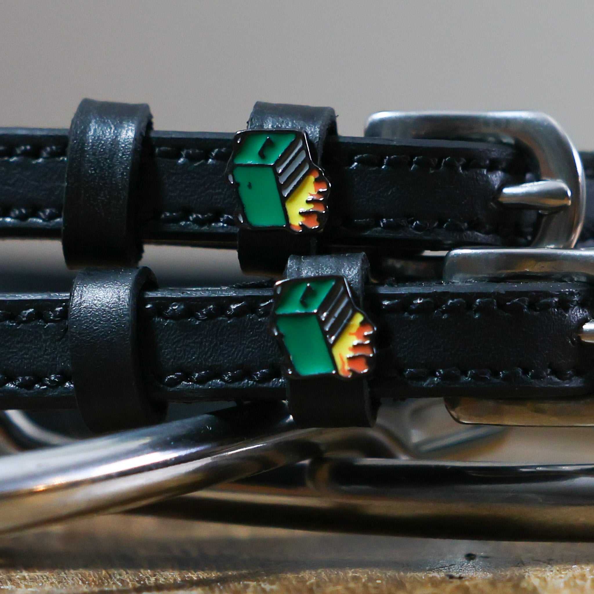 Black leather Dumpster Fire Spur Straps with stainless steel buckle and custom dumpster fire charm