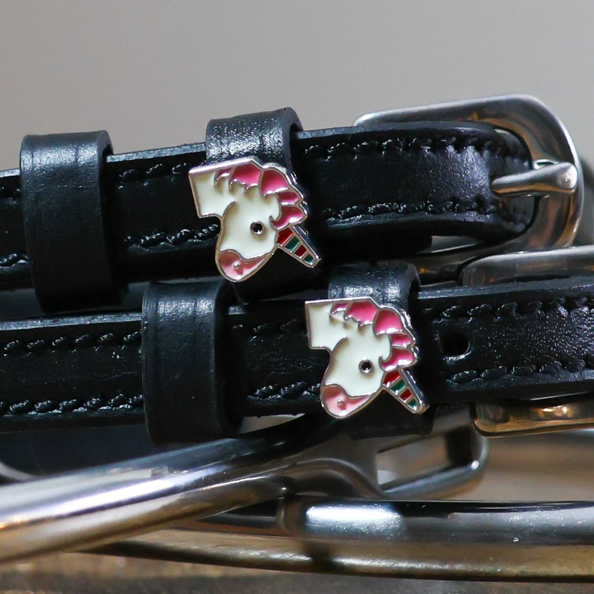 black leather Unicorn Emoji Spur Straps with stainless steel buckle and custom unicorn charm