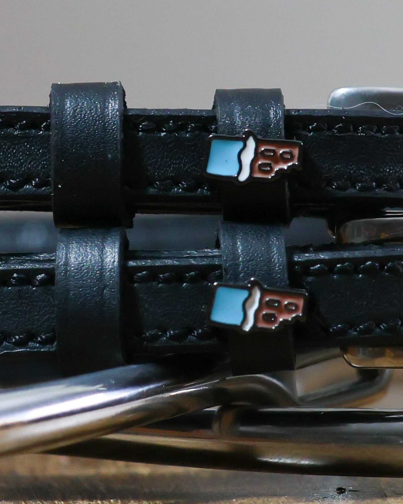 Chocolate Bar Spur Straps in black leather with stainless steel buckle and custom chocolate bar charm