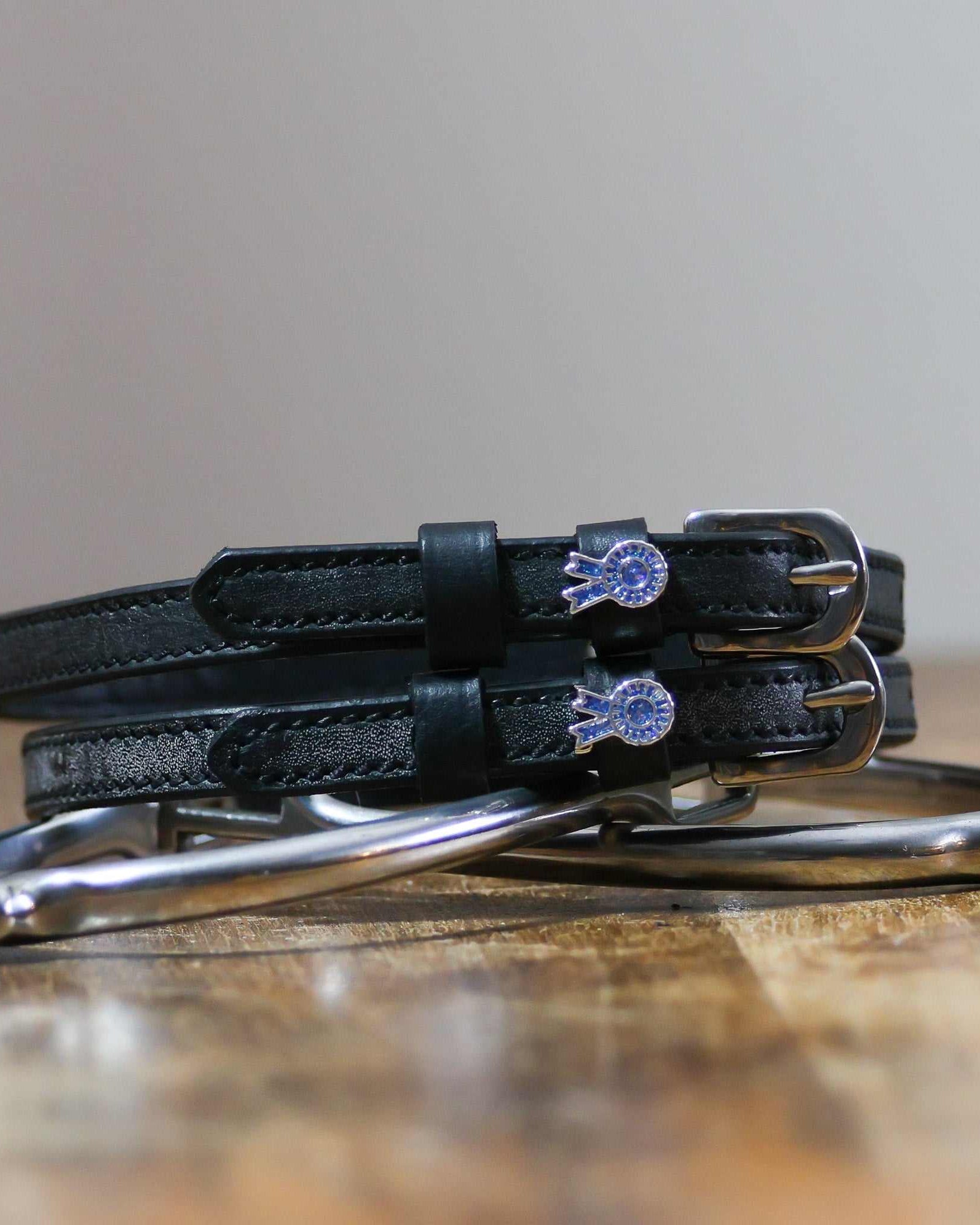 ManeJane Blue Ribbon Spur Straps Spur Straps — black leather, non-stretch, hero image for English riders.
