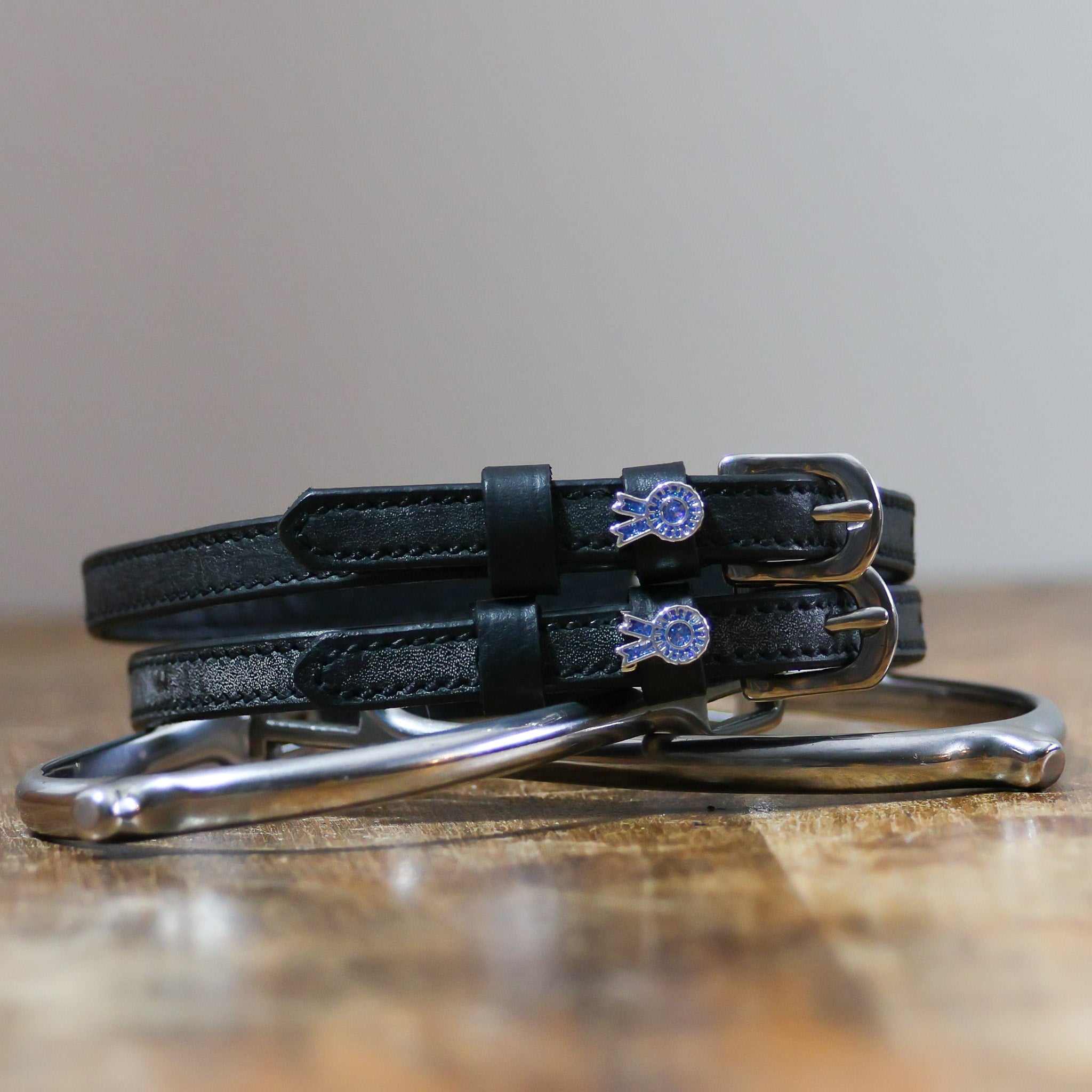 ManeJane Blue Ribbon Spur Straps Spur Straps — black leather, non-stretch, hero image for English riders.