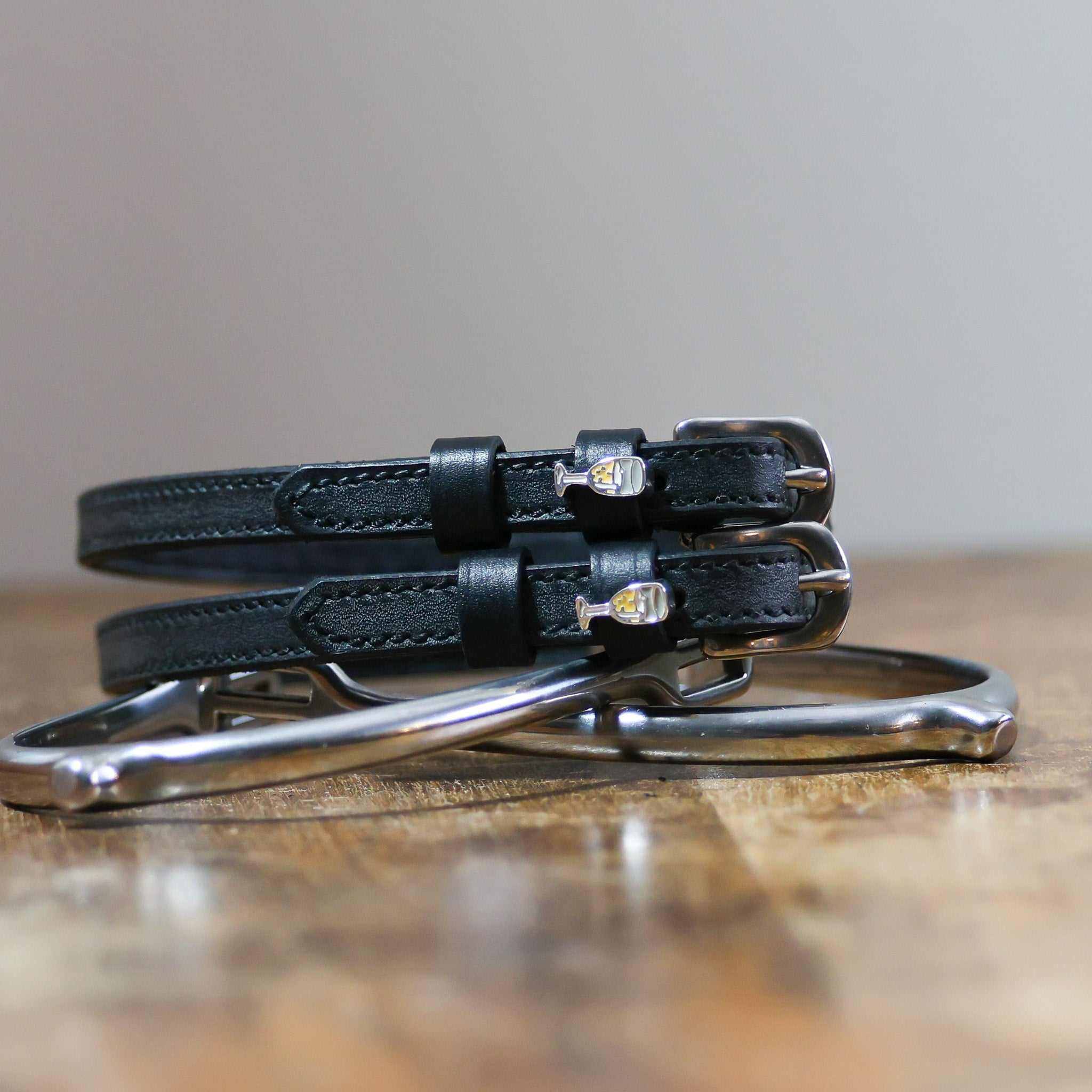 ManeJane Champagne Spur Straps Spur Straps — black leather, non-stretch, hero image for English riders.