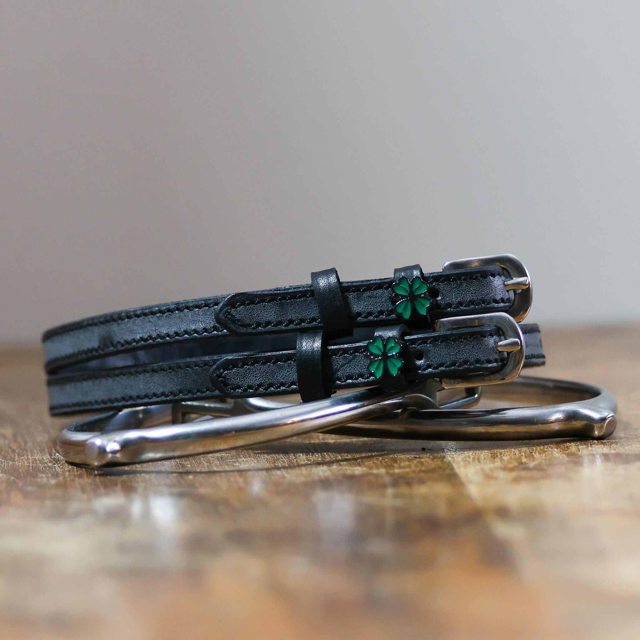 ManeJane Four Leaf Clover Spur Strap Spur Straps — black leather, non-stretch, hero image for English riders.