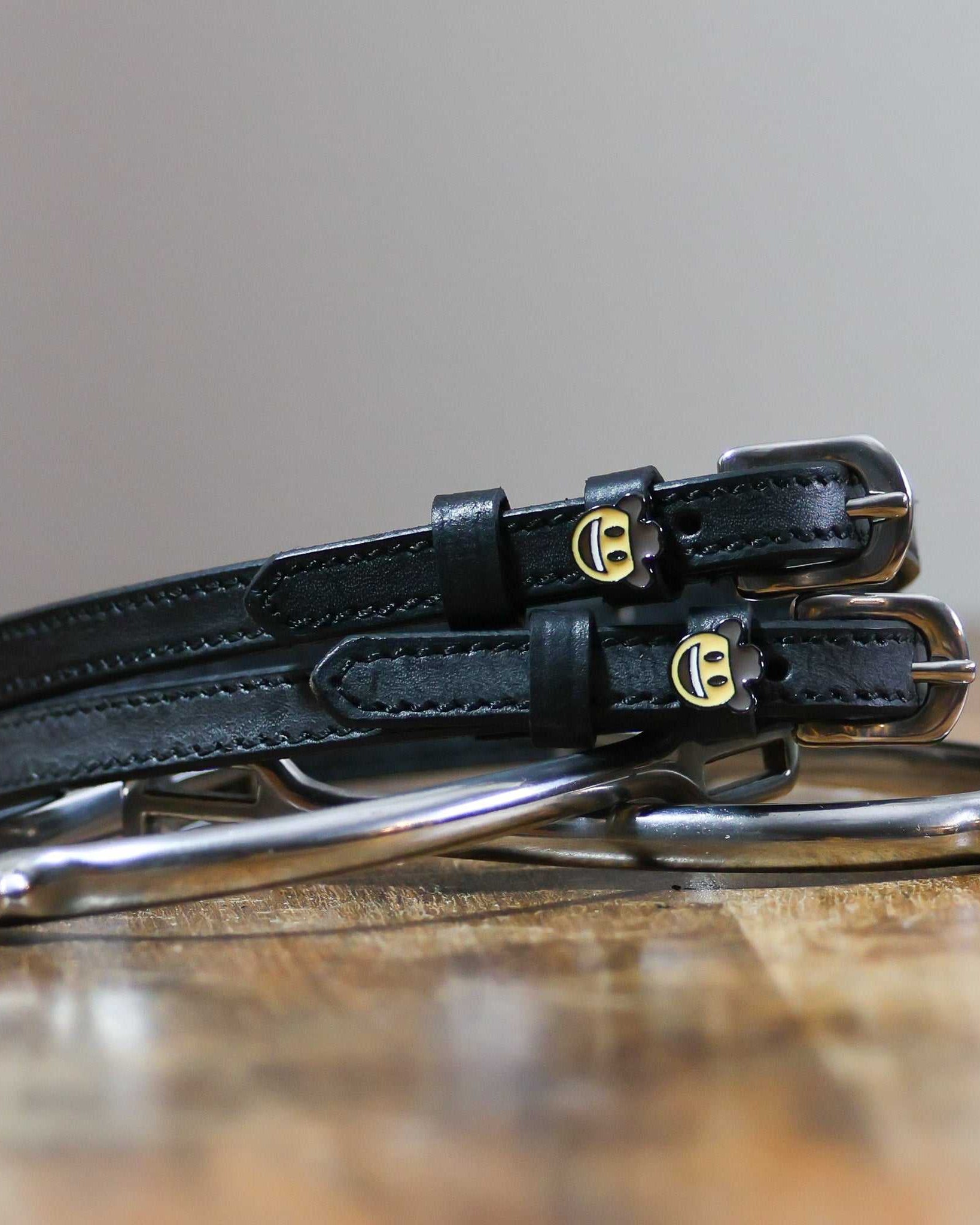 ManeJane Cowboy Emoji Spur Strap Spur Straps — black leather, non-stretch, hero image for English riders.