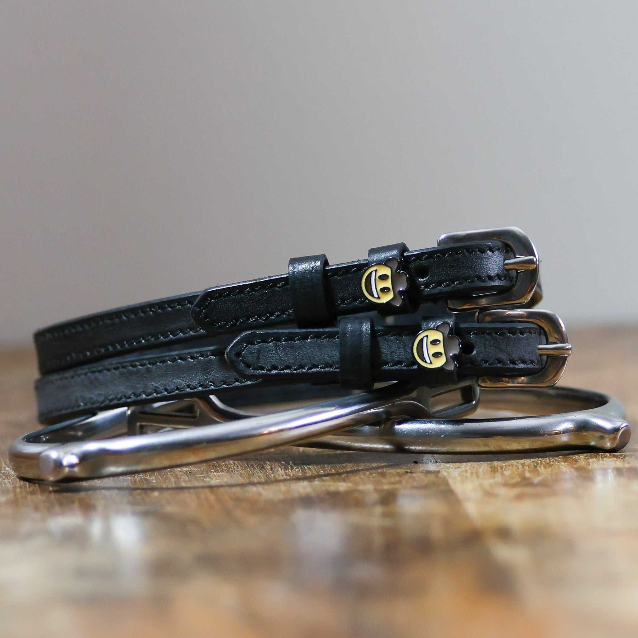 ManeJane Cowboy Emoji Spur Strap Spur Straps — black leather, non-stretch, hero image for English riders.