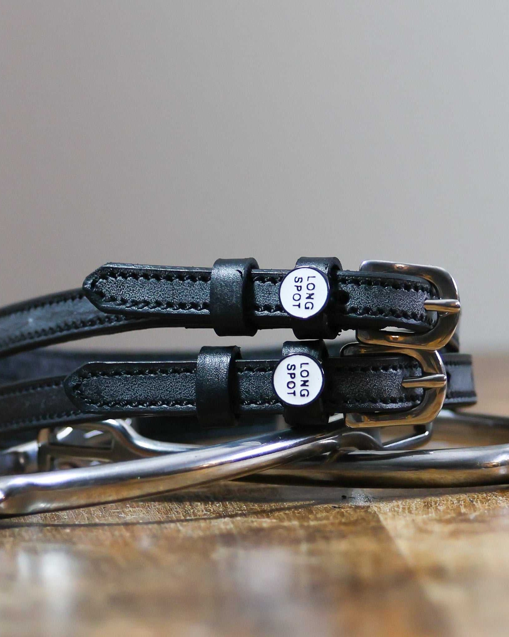 ManeJane Long Spot Spur Straps Spur Straps — black leather, non-stretch, hero image for English riders.