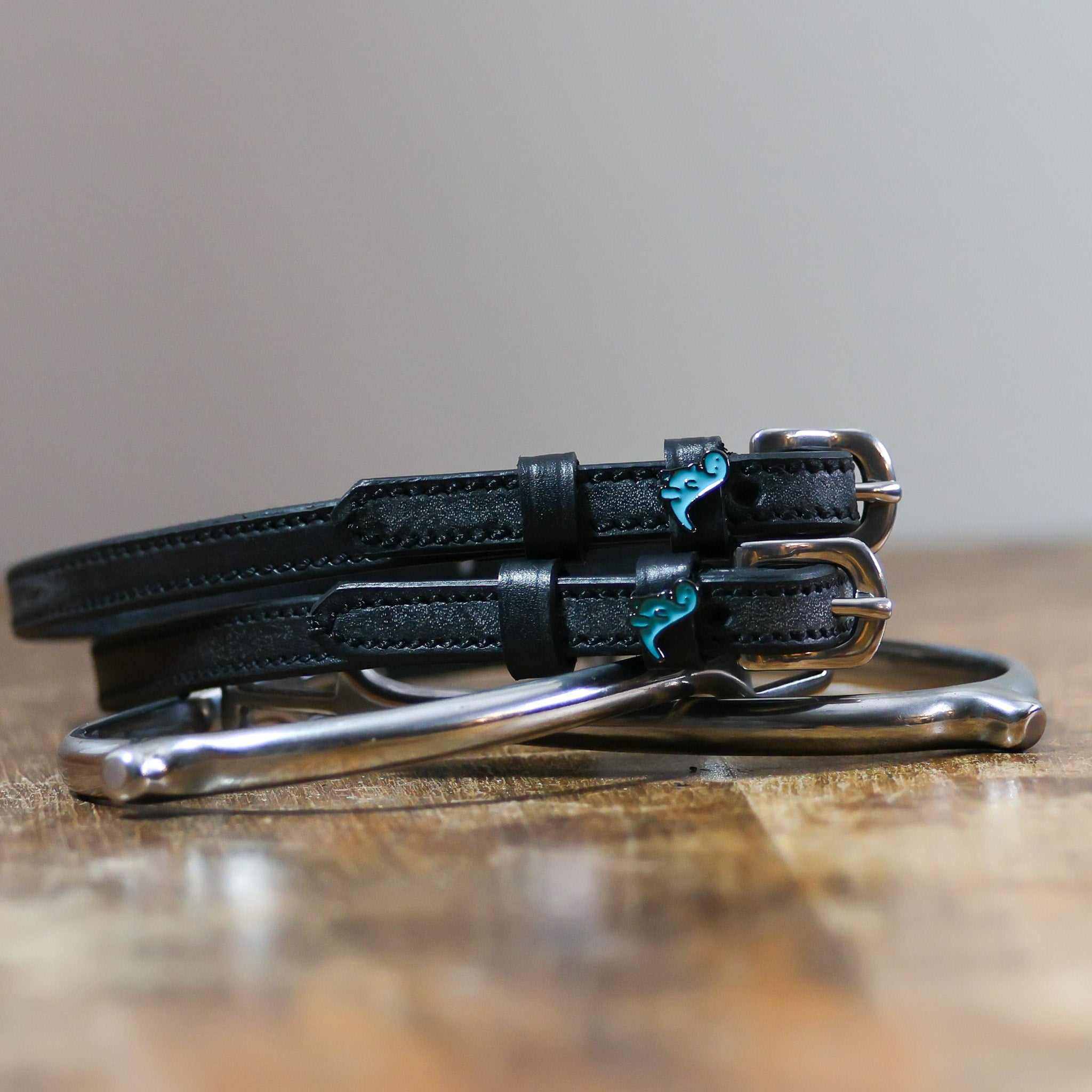 ManeJane Nice Dino Spur Straps Spur Straps — black leather, non-stretch, hero image for English riders.