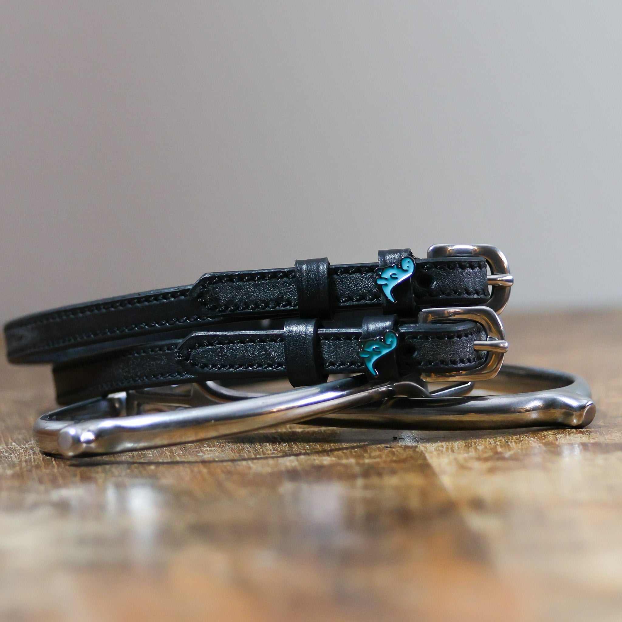 ManeJane Nice Dino Spur Straps Spur Straps — black leather, non-stretch, hero image for English riders.