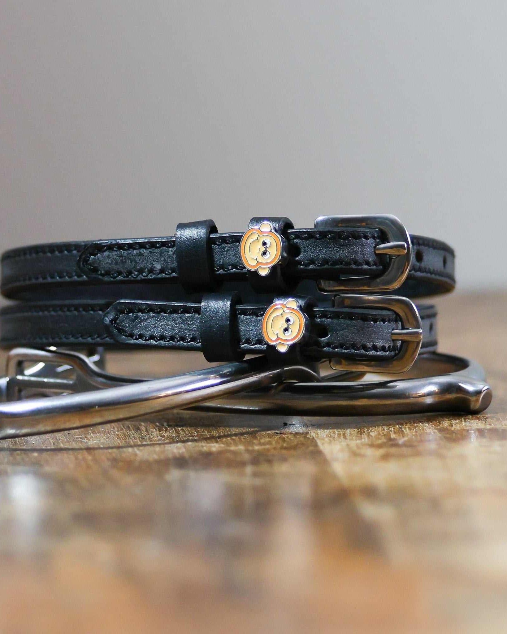 ManeJane Monkey Faces Spur Straps Spur Straps — black leather, non-stretch, hero image for English riders.