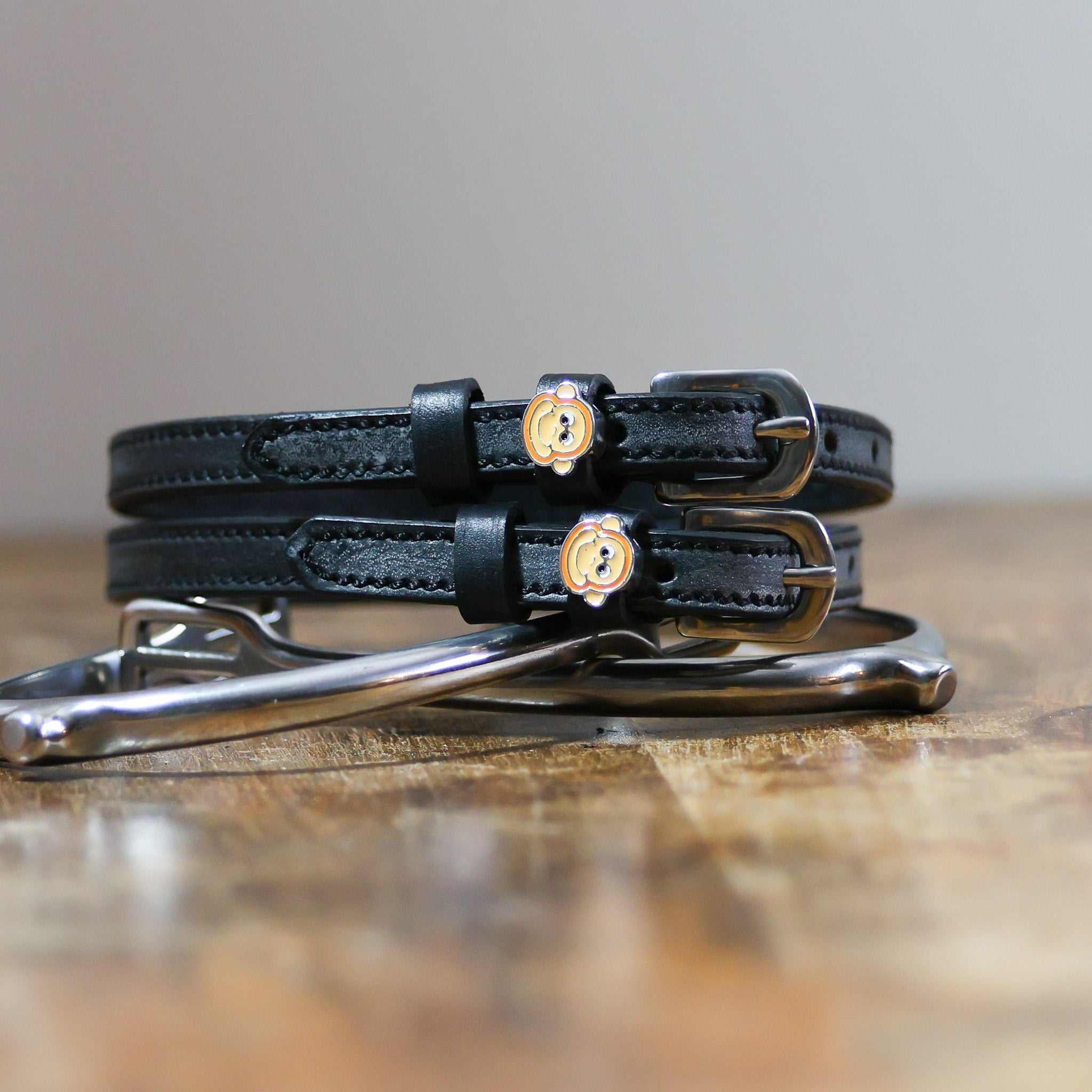 ManeJane Monkey Faces Spur Straps Spur Straps — black leather, non-stretch, hero image for English riders.