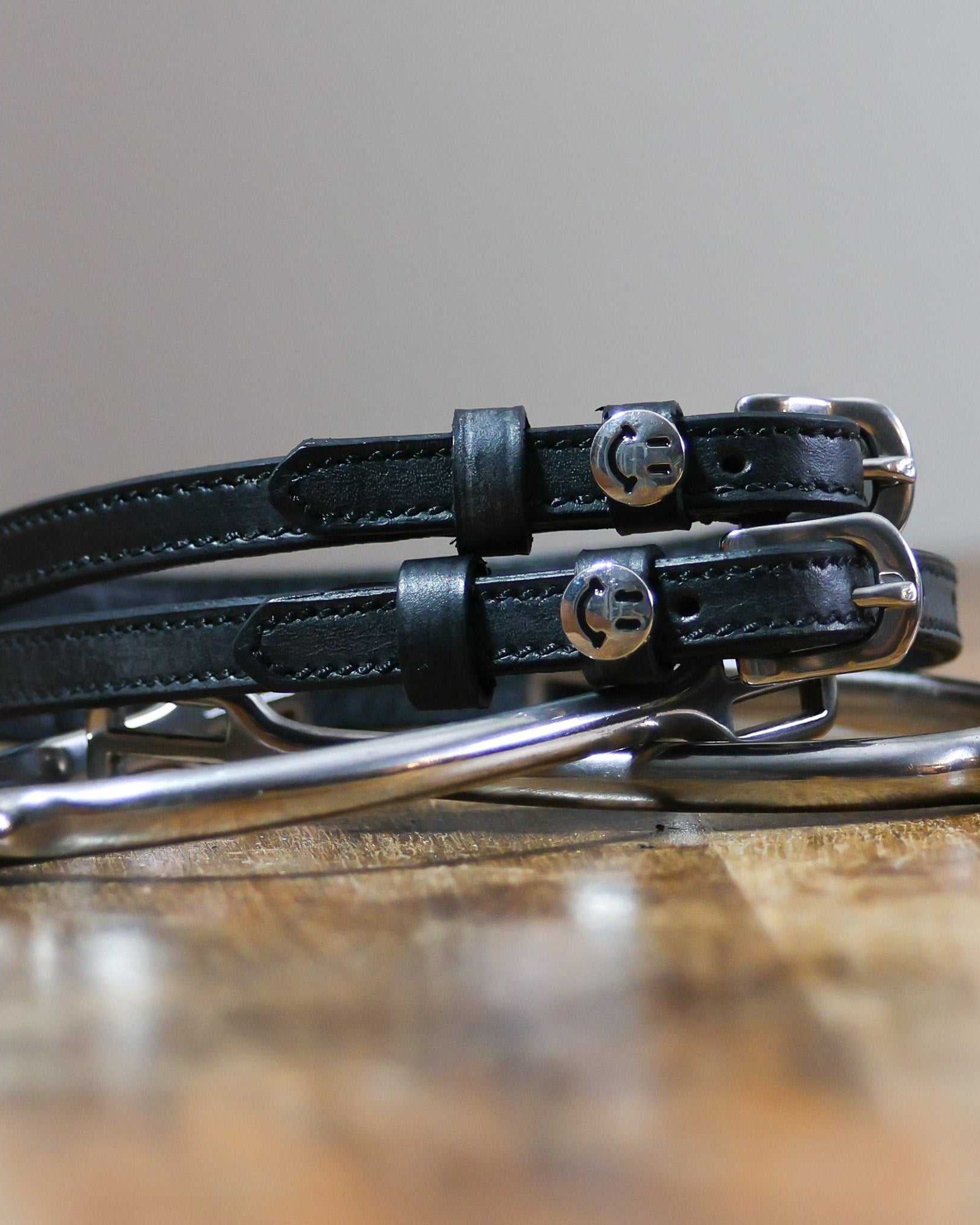 ManeJane Happy Face Spur Straps Spur Straps — black leather, non-stretch, hero image for English riders.