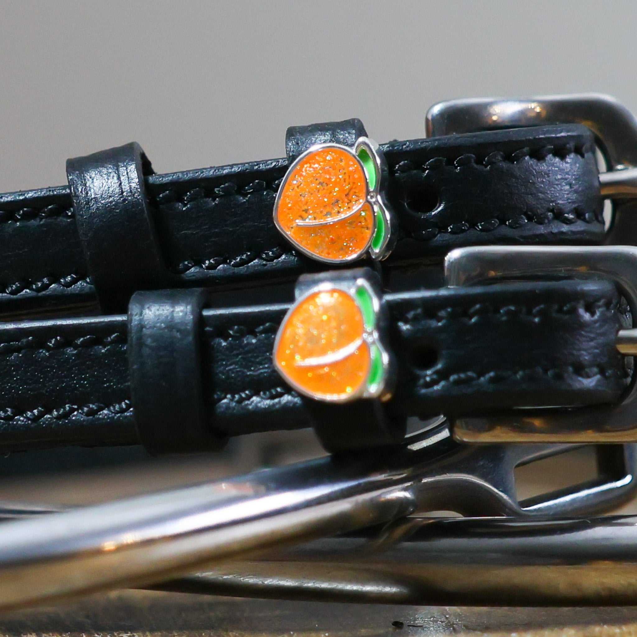 Black leather Peach Spur Straps with peach charm and stainless steel buckle
