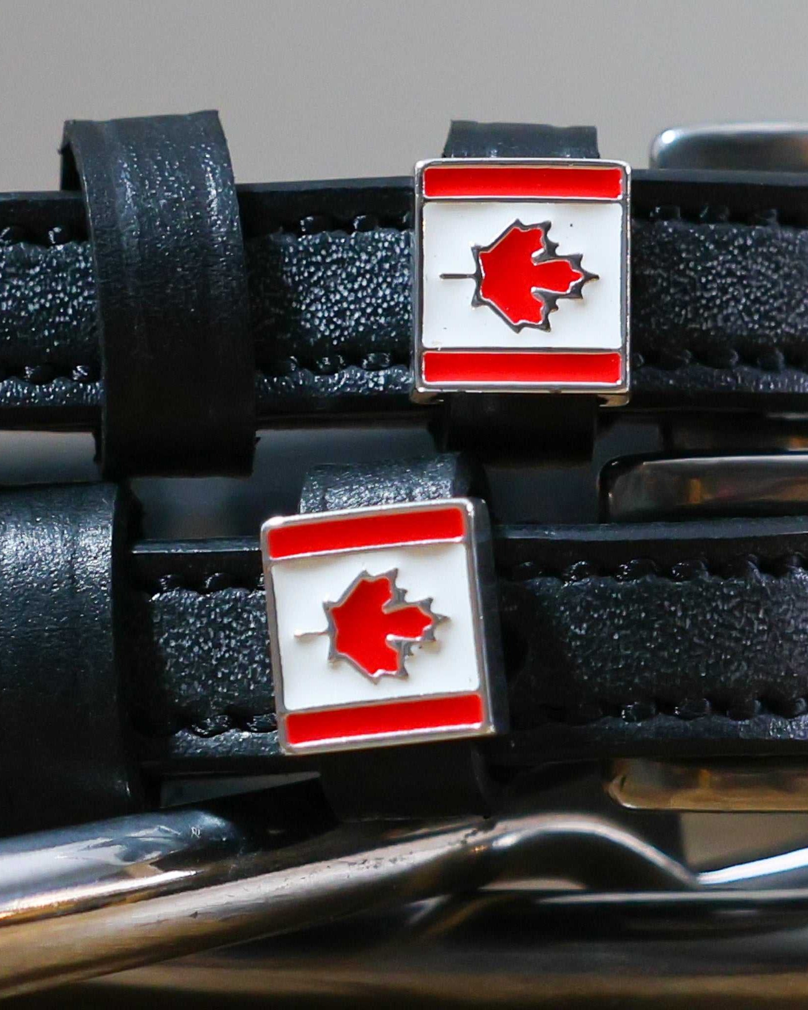 Black leather Canadian Flag Spur Straps with stainless steel buckles and custom maple leaf charms