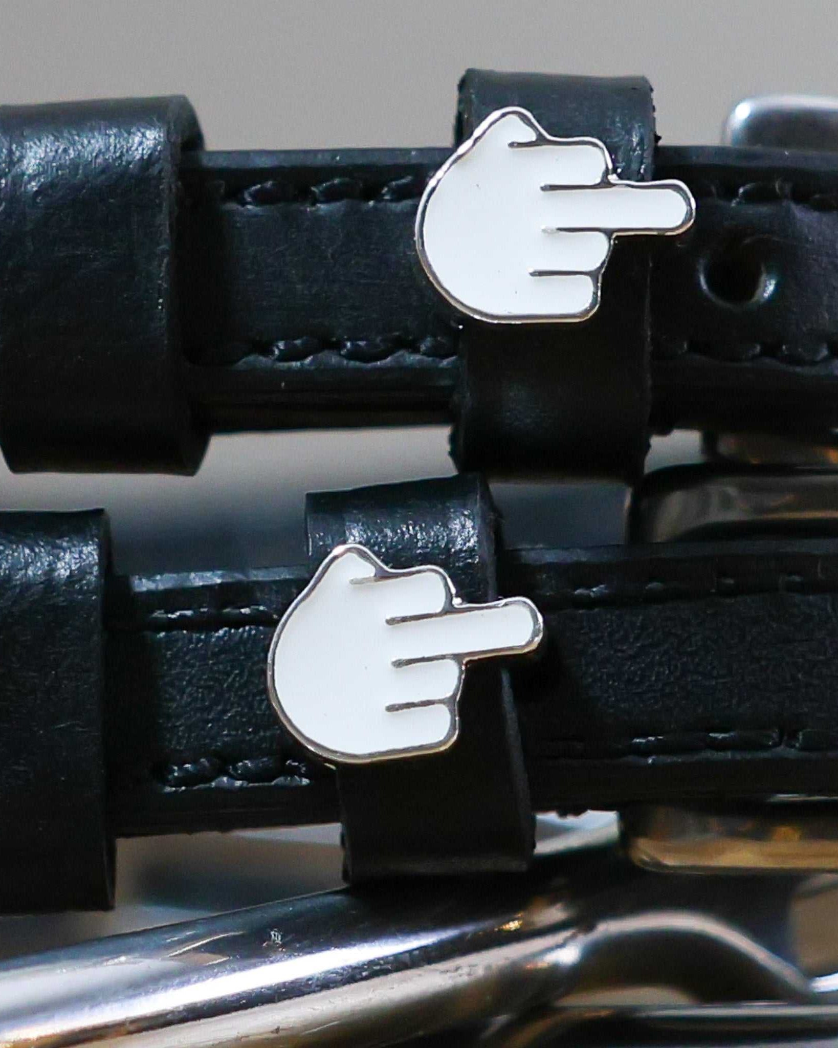 Black leather spur straps with custom metal hand gesture charms and stainless steel buckles