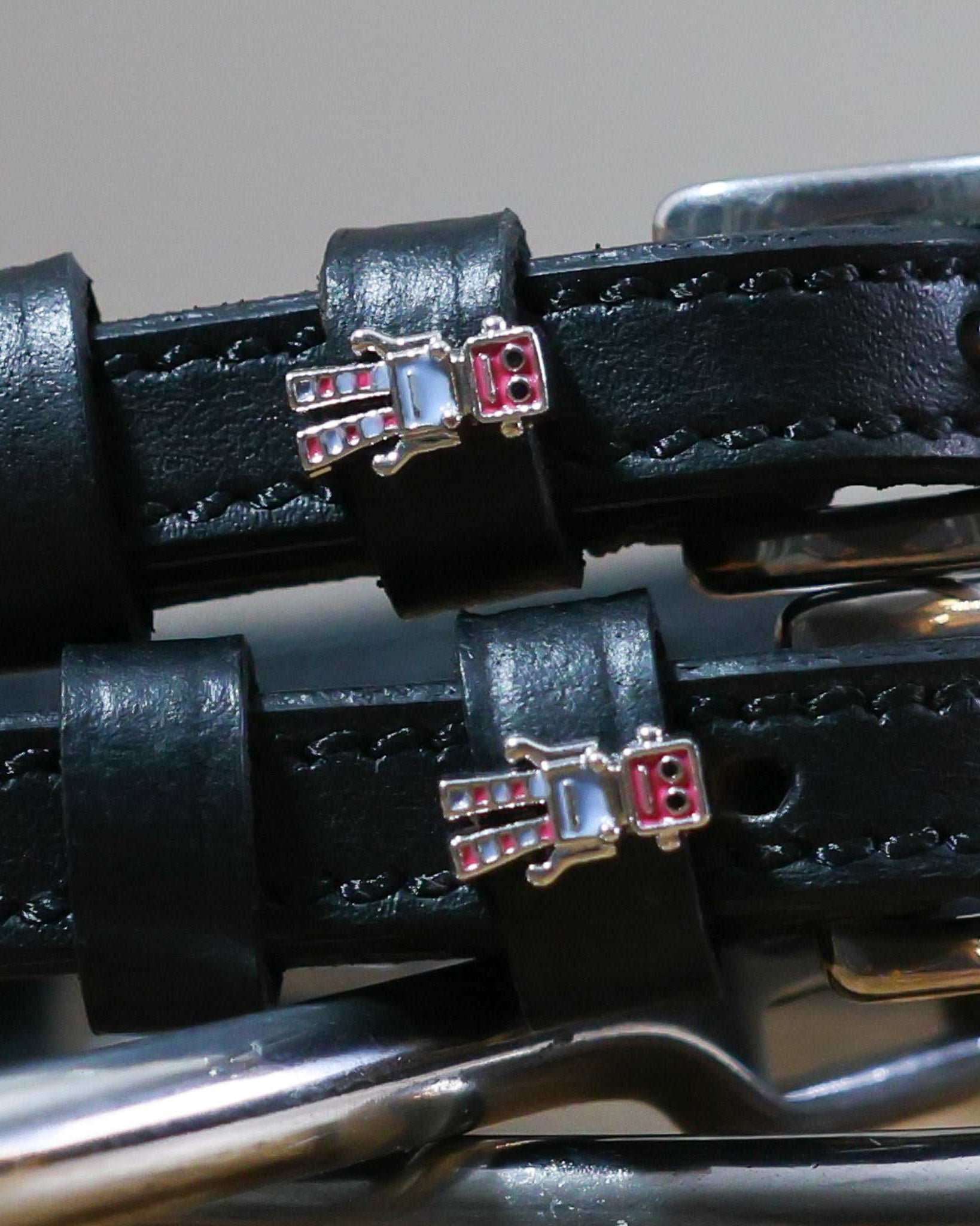 Close-up of black leather Robot Spur Straps with robot charm and stainless steel buckle