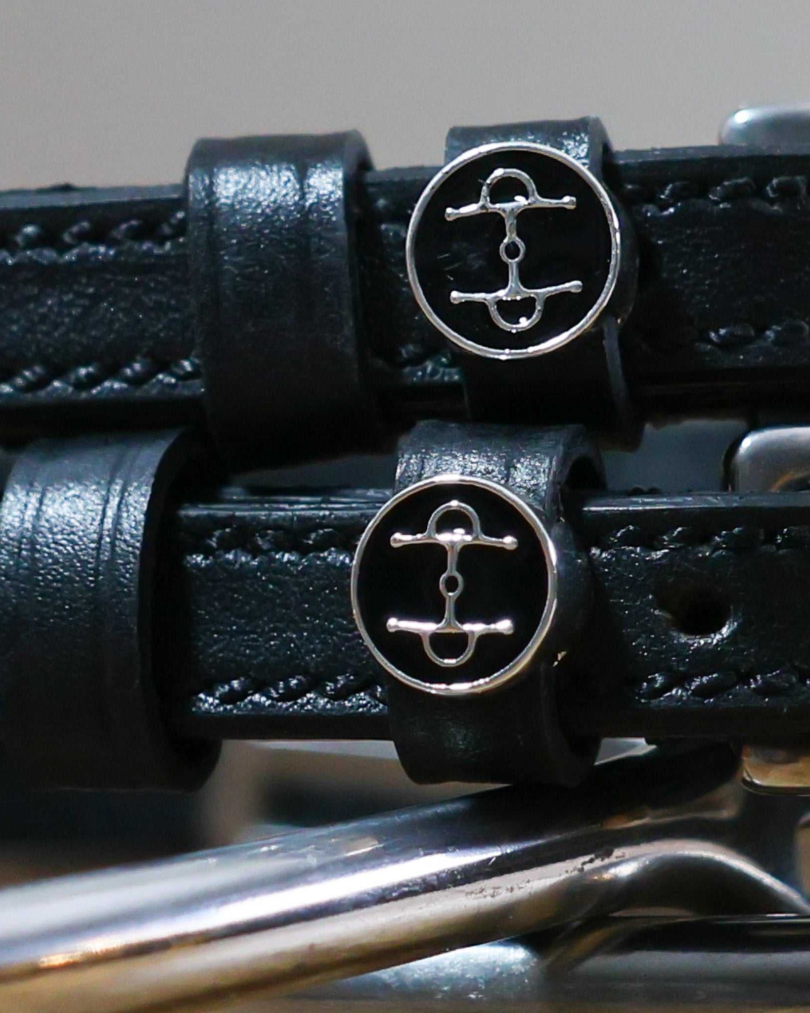 Black leather Full Cheek Spur Straps with stainless steel buckle and custom ManeJane charm