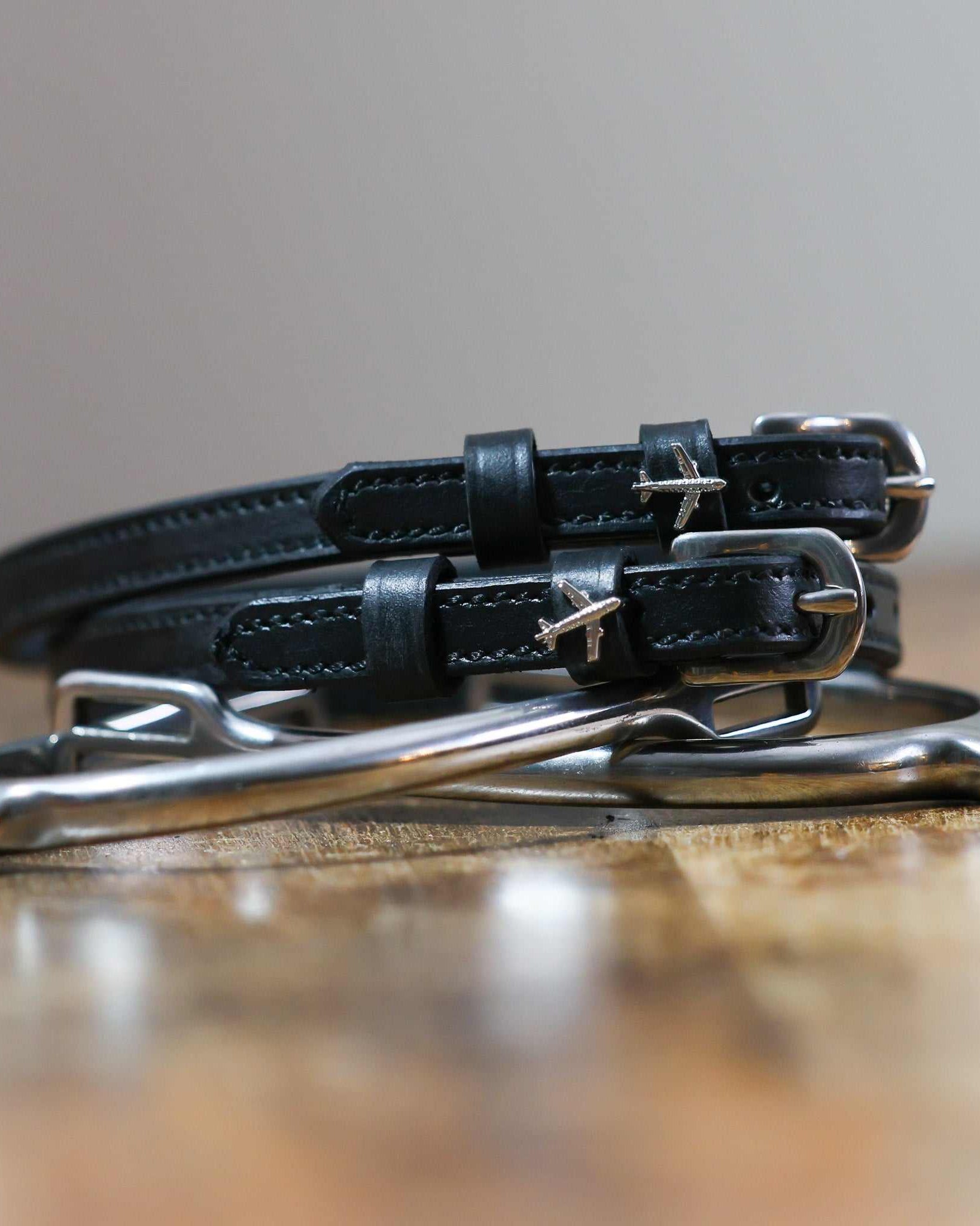 ManeJane Plane Spur Straps Spur Straps — black leather, non-stretch, hero image for English riders.