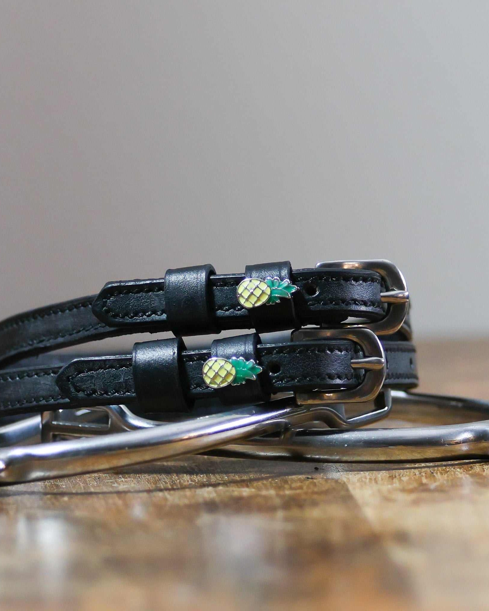 ManeJane Pineapple Spur Straps Spur Straps — black leather, non-stretch, hero image for English riders.