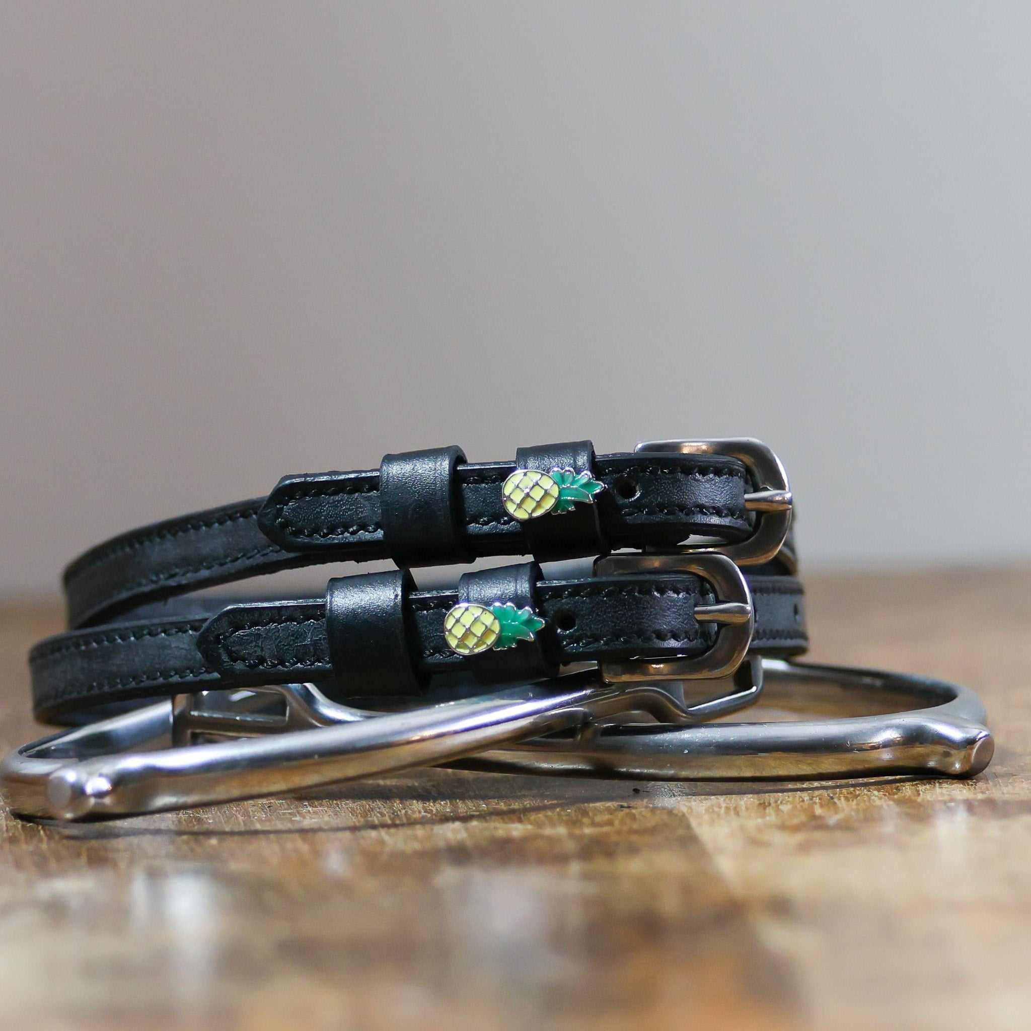 ManeJane Pineapple Spur Straps Spur Straps — black leather, non-stretch, hero image for English riders.