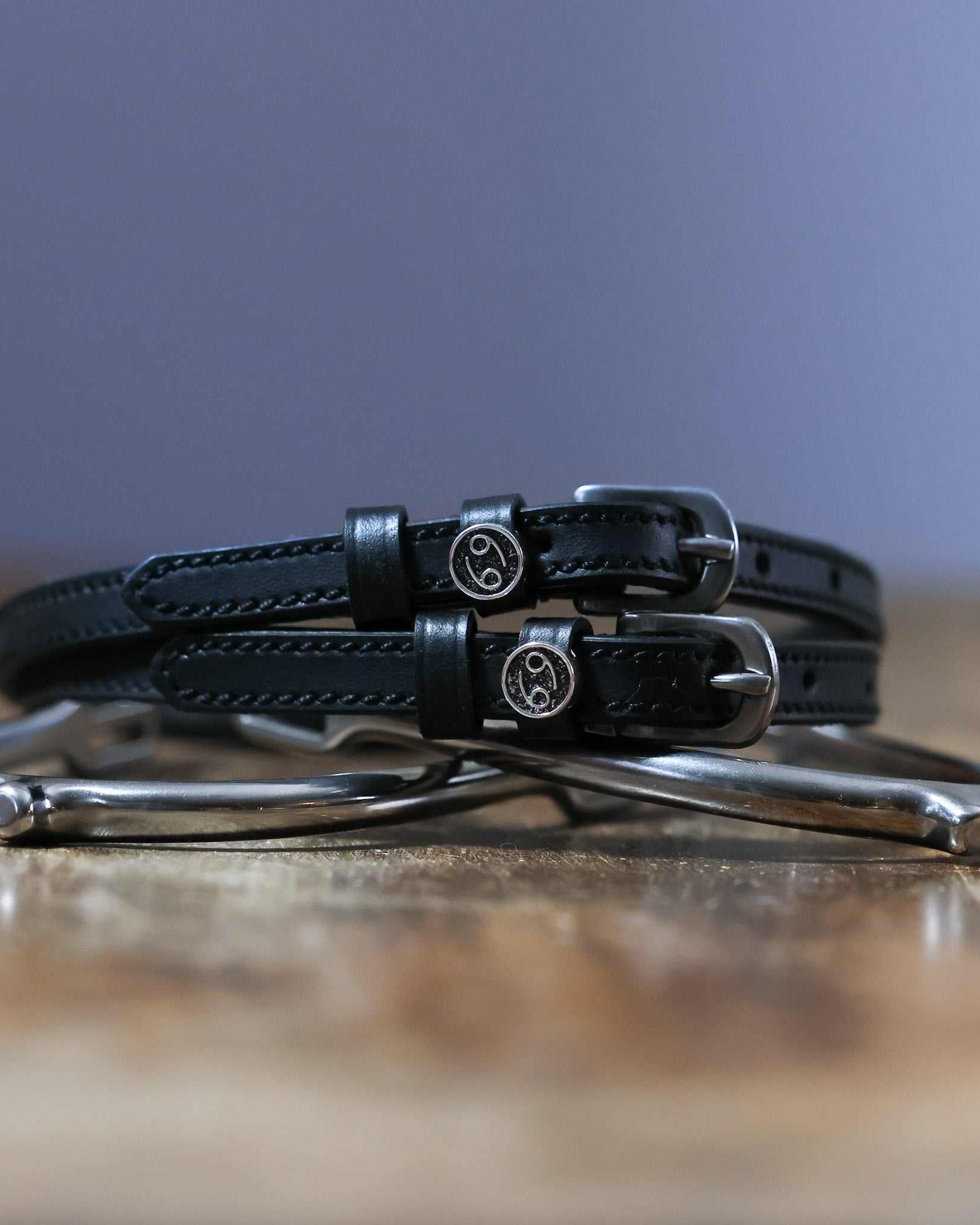 Black leather Cancer Spur Straps with stainless steel buckles and custom charms on spurs