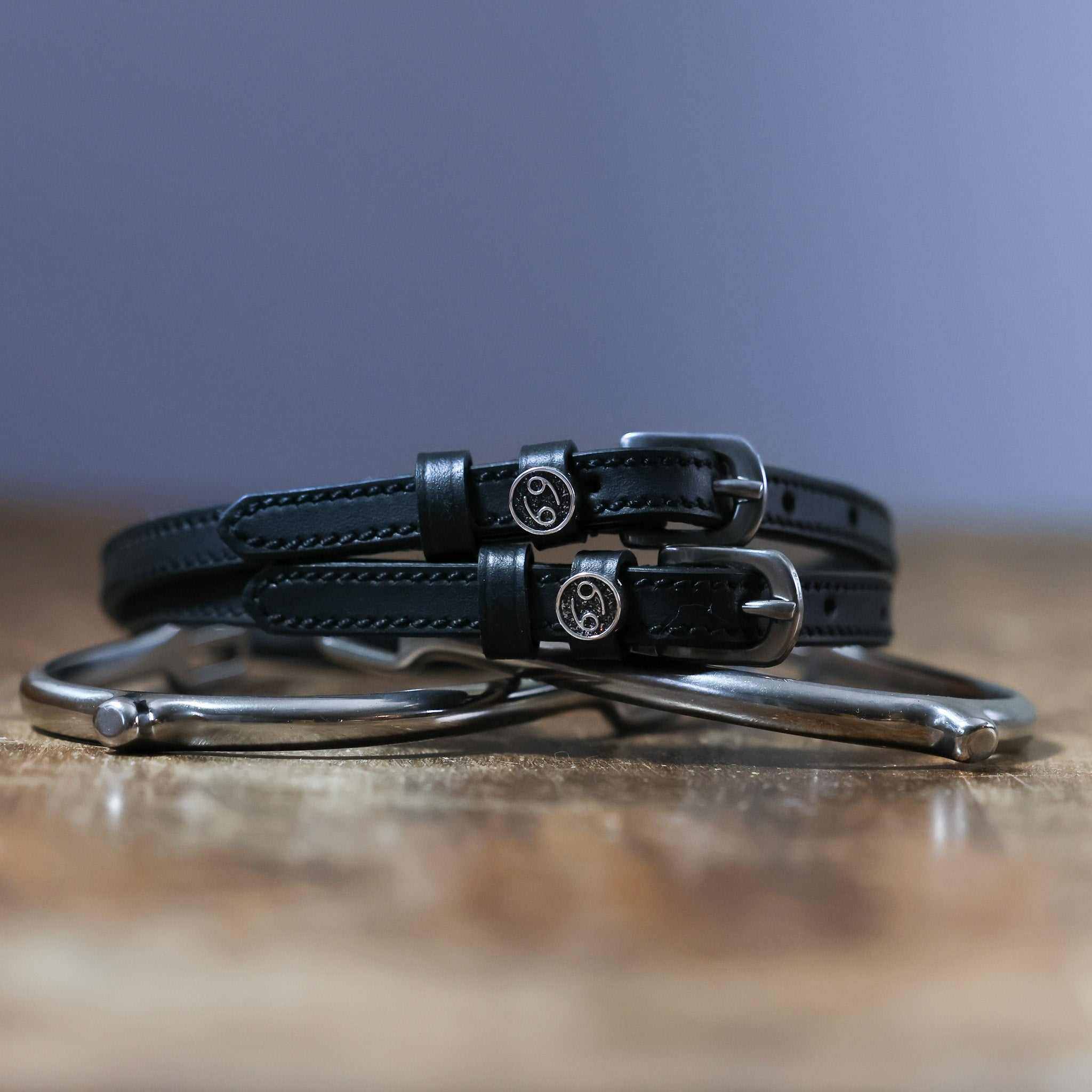 Black leather Cancer Spur Straps with stainless steel buckles and custom charms on spurs