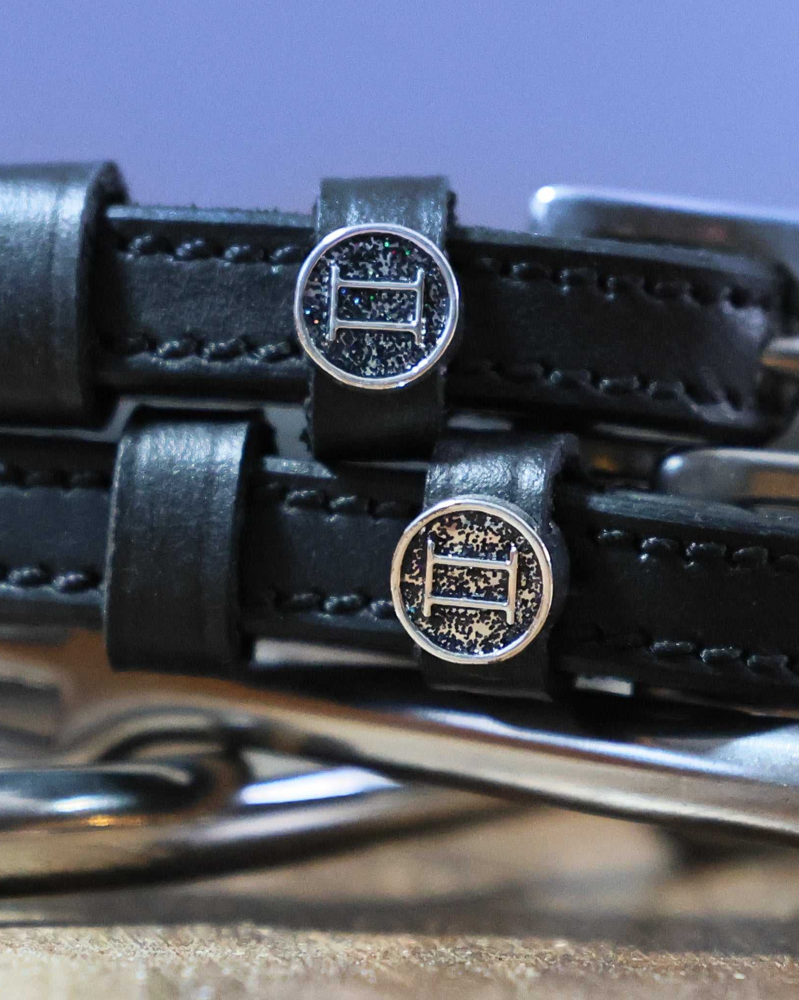 Gemini Spur Straps black leather hand-crafted with stainless steel buckle and custom charm close-up