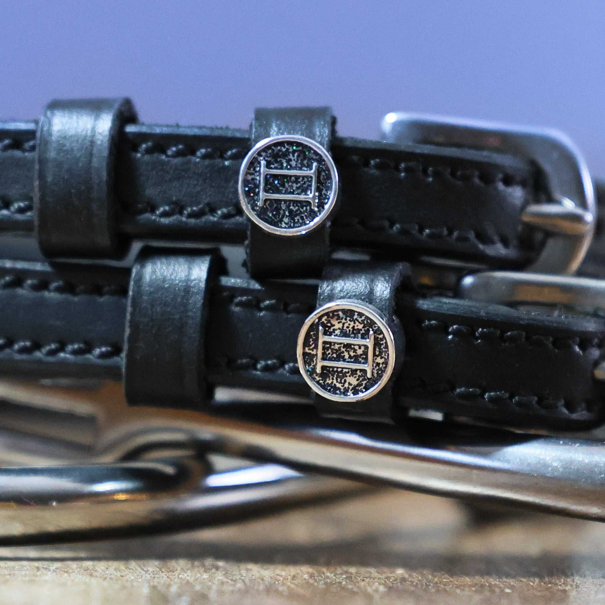 Gemini Spur Straps black leather hand-crafted with stainless steel buckle and custom charm close-up
